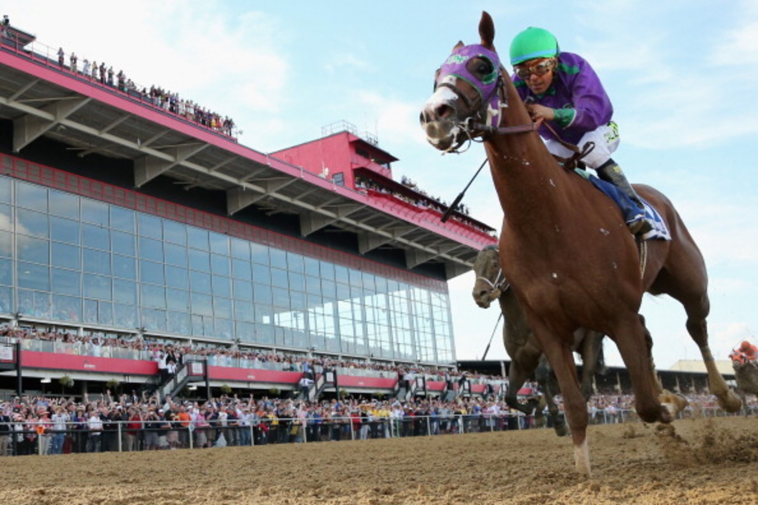 BALTIMORE, MD - MAY 17:  California Chrome #3, ridden by Victor Espinoza, races to the finish line enroute to winning the 139th running of the Preakness Stakes at Pimlico Race Course on May 17, 2014 in Baltimore, Maryland.  (Photo by Rob Carr/Getty Images