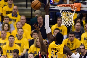 May 18, 2014; Indianapolis, IN, USA;Miami Heat guard Mario Chalmers (15) has his shot blocked by Indiana Pacers center Roy Hibbert (55) during the first period of game one of the Eastern Conference Finals of the 2014 NBA Playoffs at Bankers Life Fieldhous