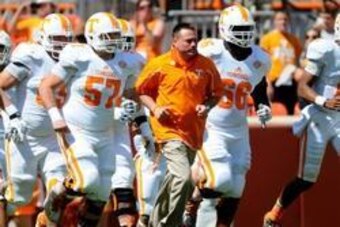 Apr 12, 2014; Knoxville, TN, USA; Tennessee Volunteers head coach Butch Jones runs onto the field during the orange and white spring game at Neyland Stadium. Mandatory Credit: Randy Sartin-USA TODAY Sports