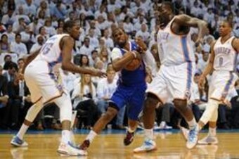 May 13, 2014; Oklahoma City, OK, USA; Los Angeles Clippers guard Chris Paul (3) drives to the basket against Oklahoma City Thunder forward Kevin Durant (35) and Oklahoma City Thunder center Kendrick Perkins (5) during the first quarter in game five of the