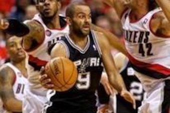 May 10, 2014; Portland, OR, USA; San Antonio Spurs guard Tony Parker (9) passes the ball in fron tof Portland Trail Blazers forward LaMarcus Aldridge (12) and center Robin Lopez (42) during the third quarter in game three of the second round of the 2014 N