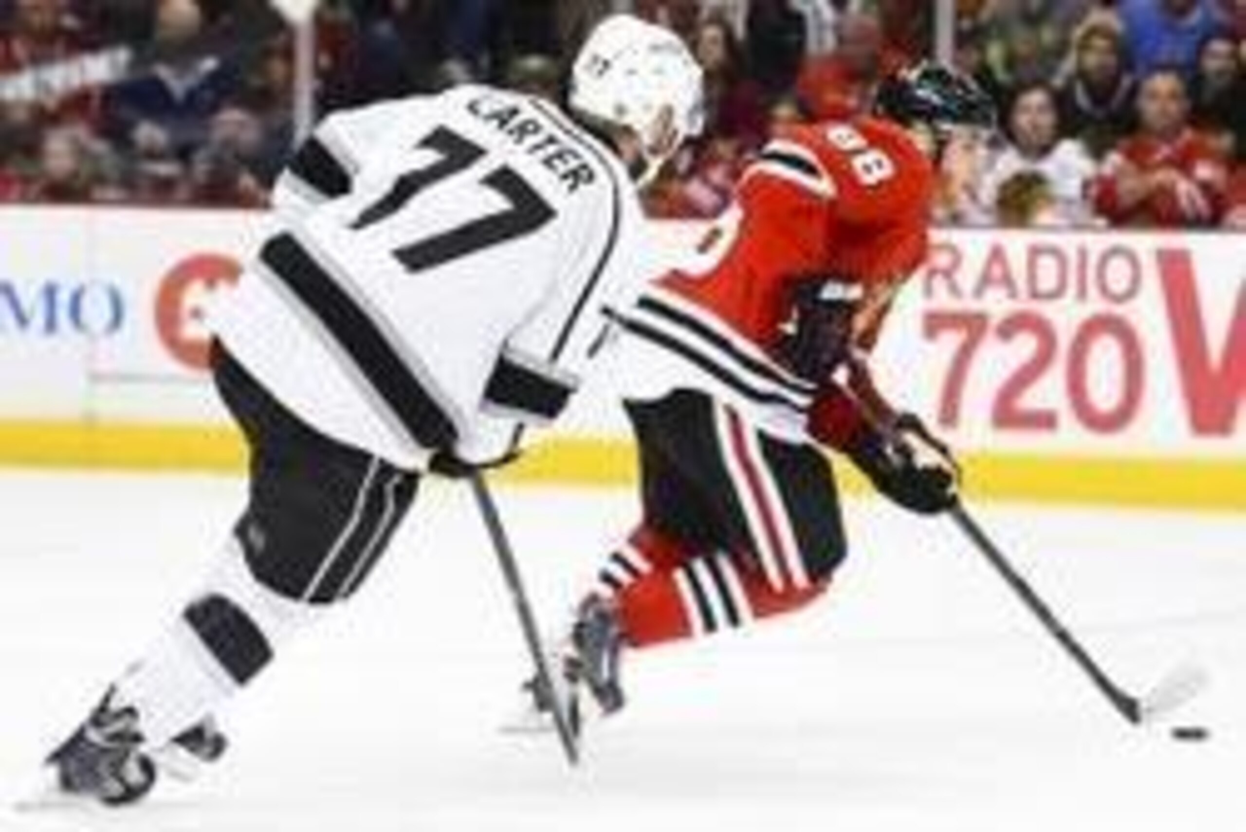 May 18, 2014; Chicago, IL, USA; Chicago Blackhawks right wing Patrick Kane (88) skates with the puck as Los Angeles Kings center Jeff Carter (77) chases in game one of the Western Conference Final of the 2014 Stanley Cup Playoffs at United Center. Mandato