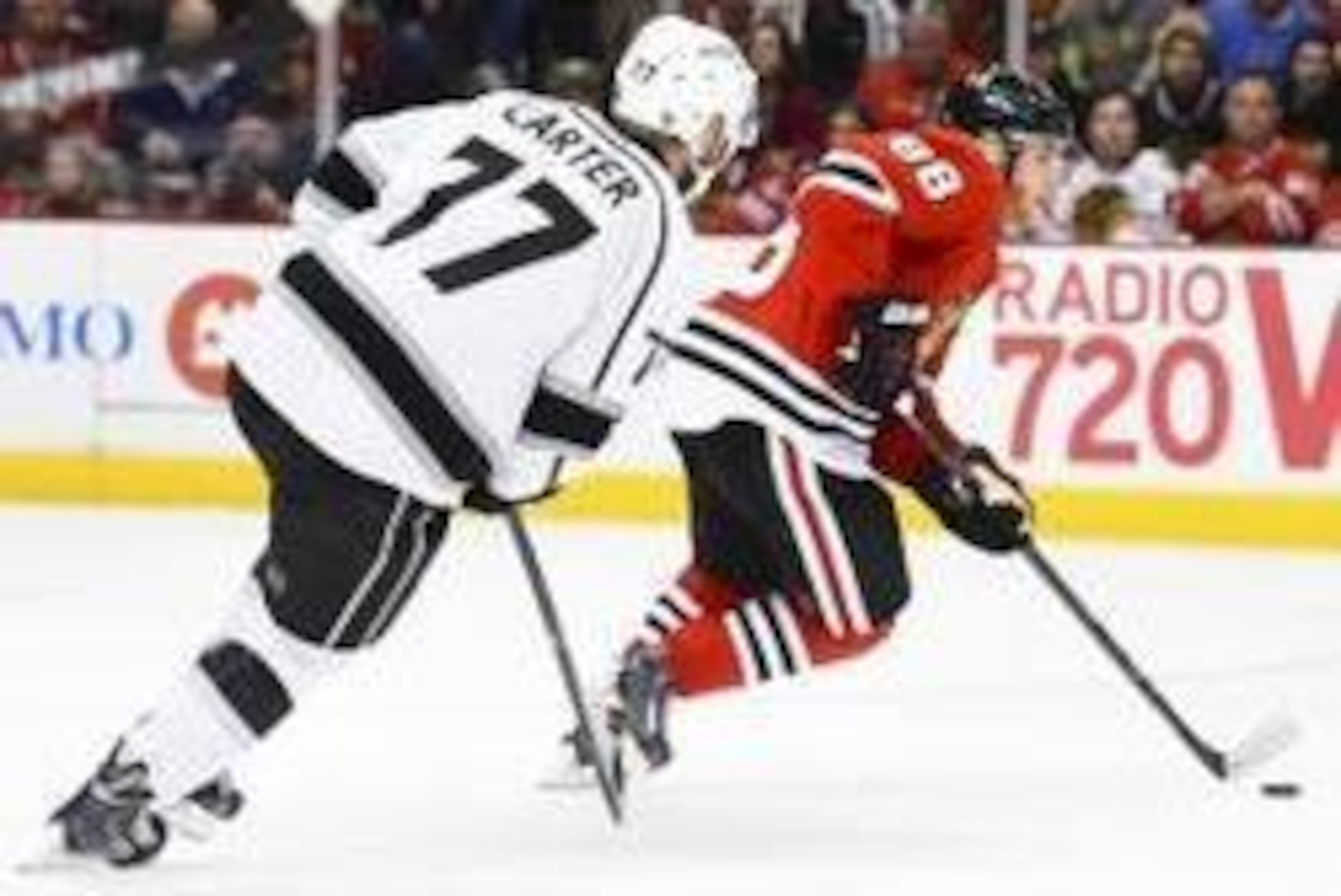 May 18, 2014; Chicago, IL, USA; Chicago Blackhawks right wing Patrick Kane (88) skates with the puck as Los Angeles Kings center Jeff Carter (77) chases in game one of the Western Conference Final of the 2014 Stanley Cup Playoffs at United Center. Mandato