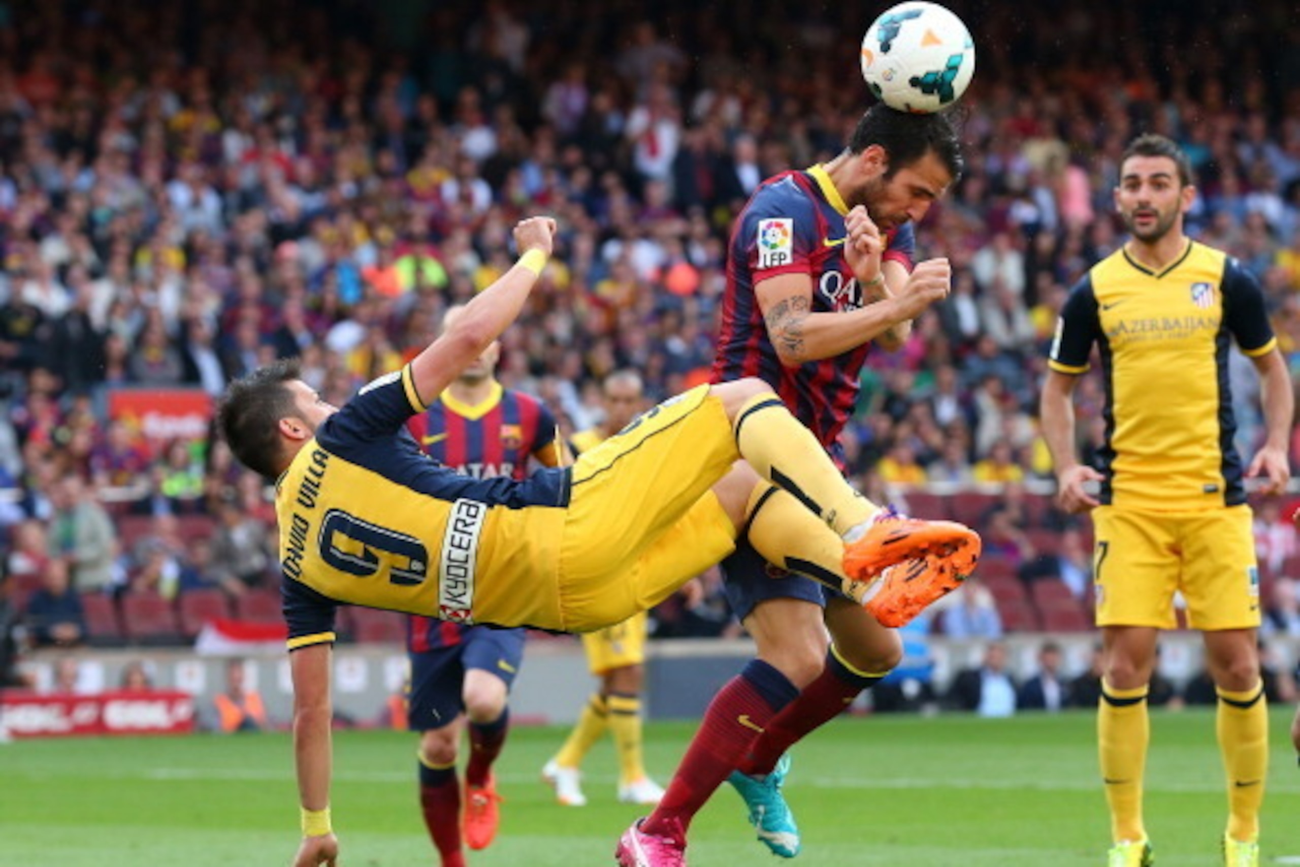 BARCELONA, SPAIN - MAY 17:  Cesc Fabregas of FC Barcelona is challeged by David Villa of Club Atletico de Madrid during the La Liga match between FC Barcelona and Club Atletico de Madrid at Camp Nou on May 17, 2014 in Barcelona, Spain.  (Photo by Alex Liv