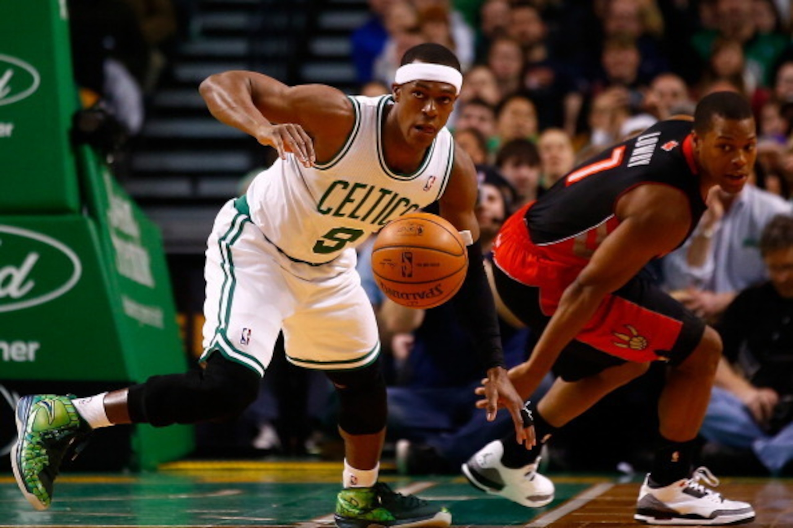 BOSTON, MA - MARCH 26: Rajon Rondo #9 of the Boston Celtics steals the ball from Kyle Lowry #7 of the Toronto Raptors in the first quarter during the game at TD Garden on March 26, 2014 in Boston, Massachusetts. NOTE TO USER: User expressly acknowledges a