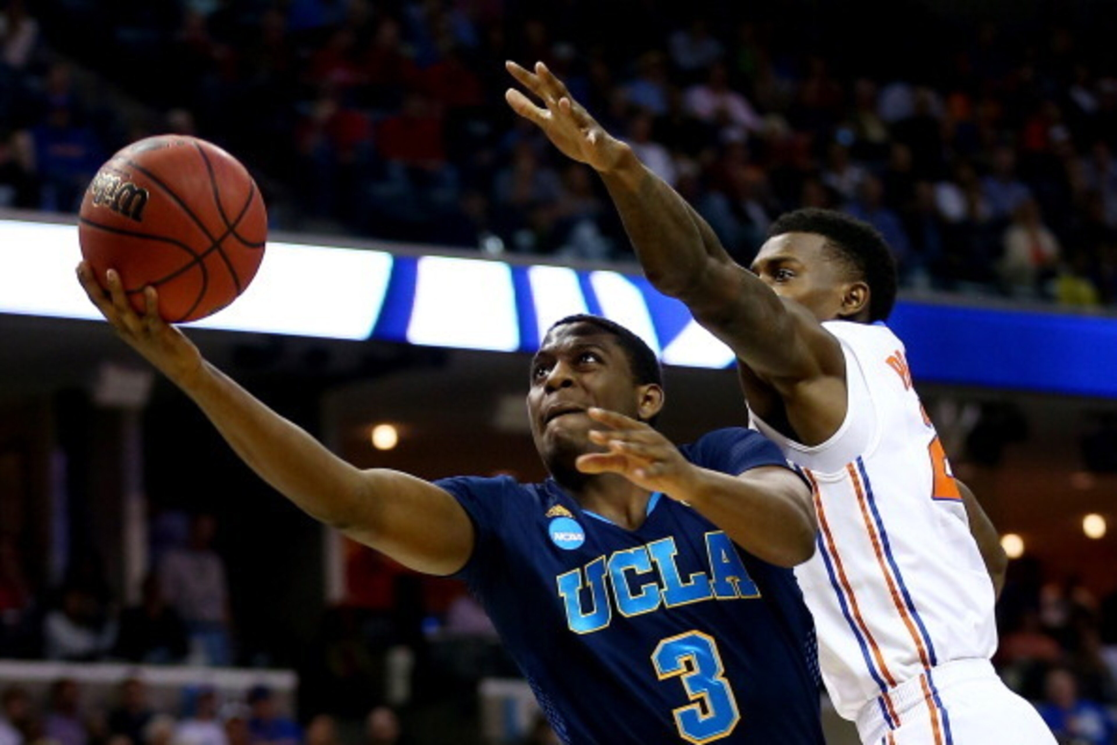 MEMPHIS, TN - MARCH 27:  Jordan Adams #3 of the UCLA Bruins goes to the basket as Casey Prather #24 of the Florida Gators defends during a regional semifinal of the 2014 NCAA Men's Basketball Tournament at the FedExForum on March 27, 2014 in Memphis, Tenn