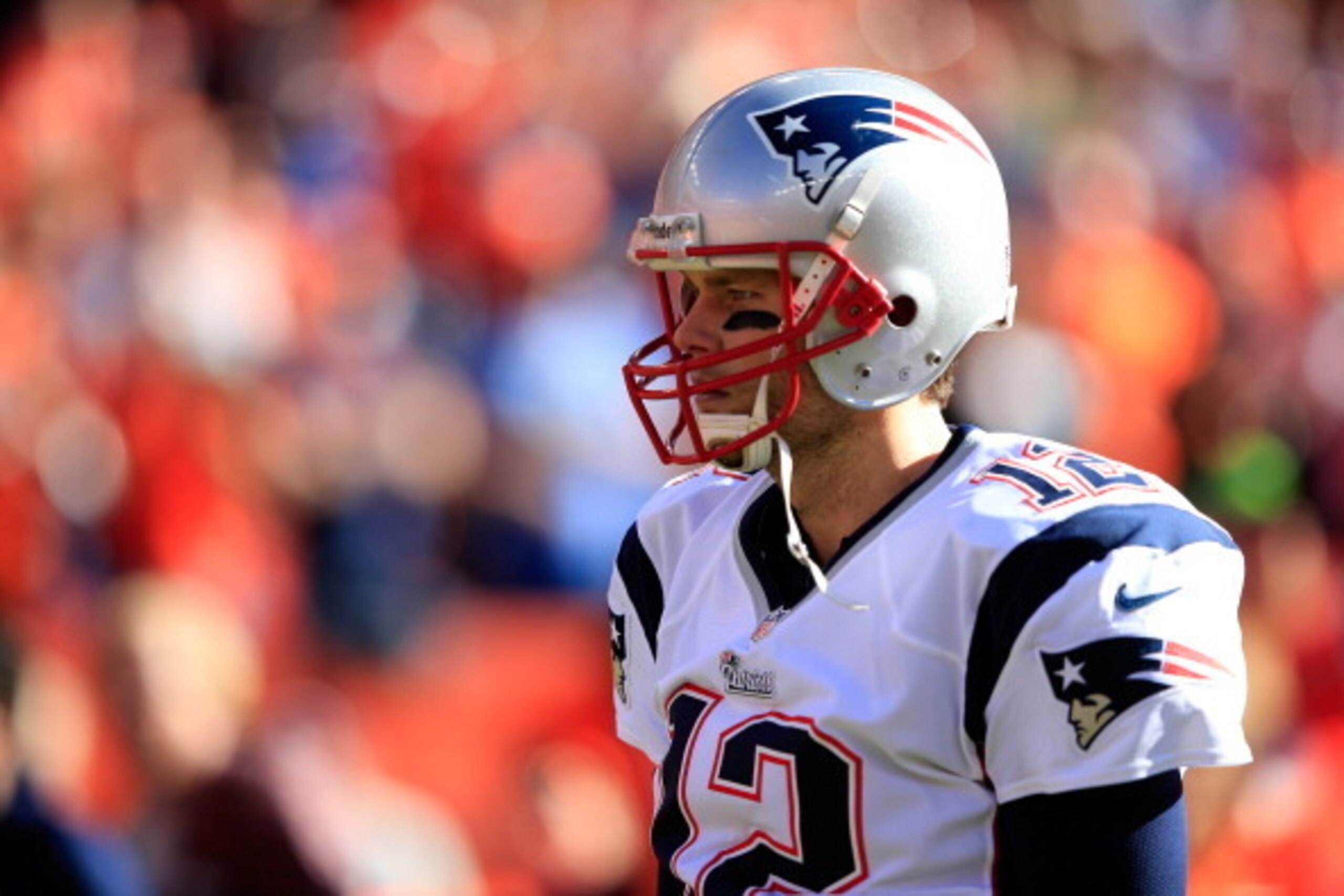 DENVER, CO - JANUARY 19:  Tom Brady #12 of the New England Patriots in action against the Denver Broncos during the AFC Championship game at Sports Authority Field at Mile High on January 19, 2014 in Denver, Colorado.  (Photo by Jamie Squire/Getty Images)