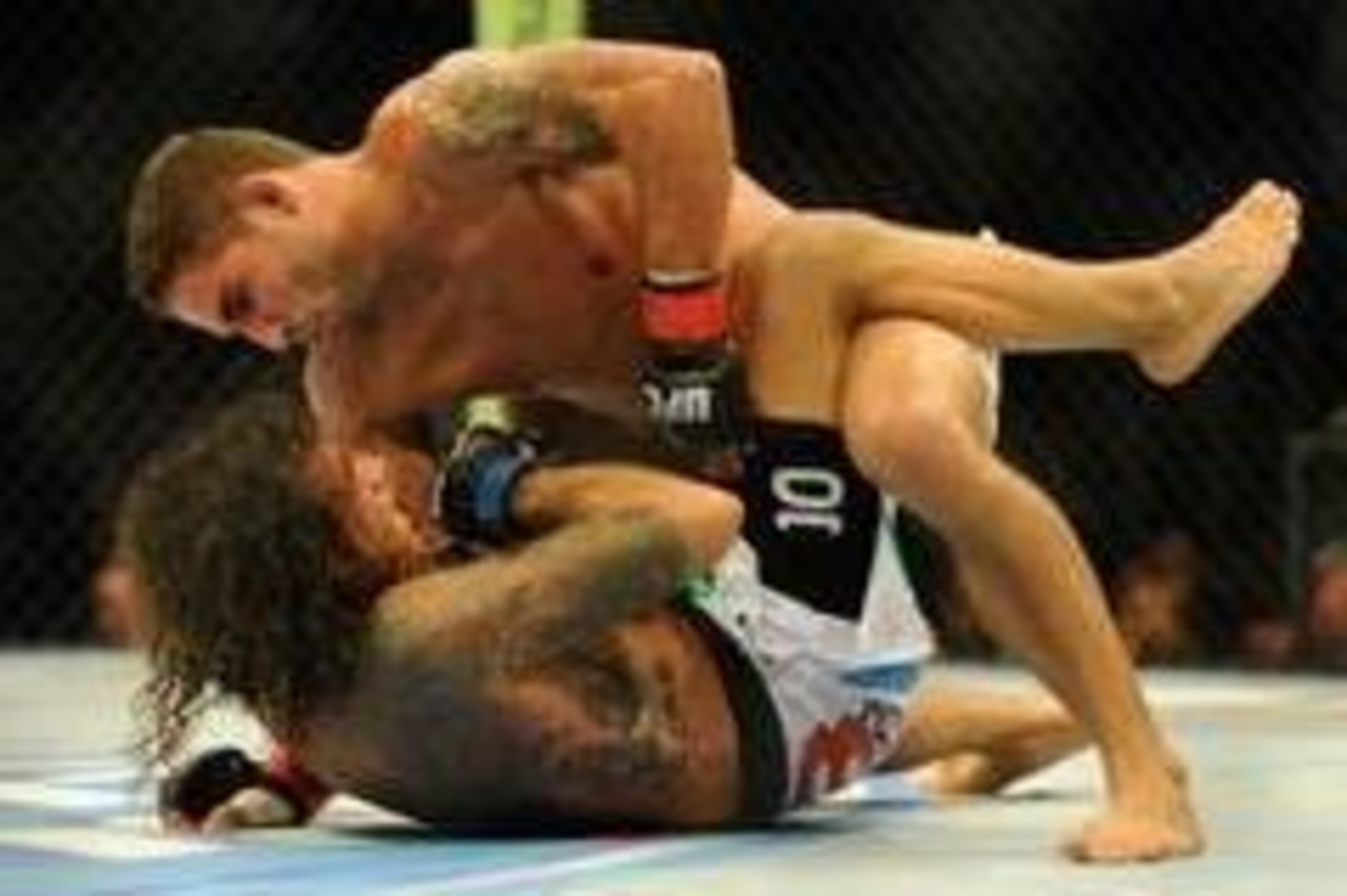 Aug 31, 2013; Milwaukee, WI, USA;  Chad Mendes (top) fights Clay Guida during the UFC-164 bout at BMO Harris Bradley Center. Mandatory Credit: Benny Sieu-USA TODAY Sports