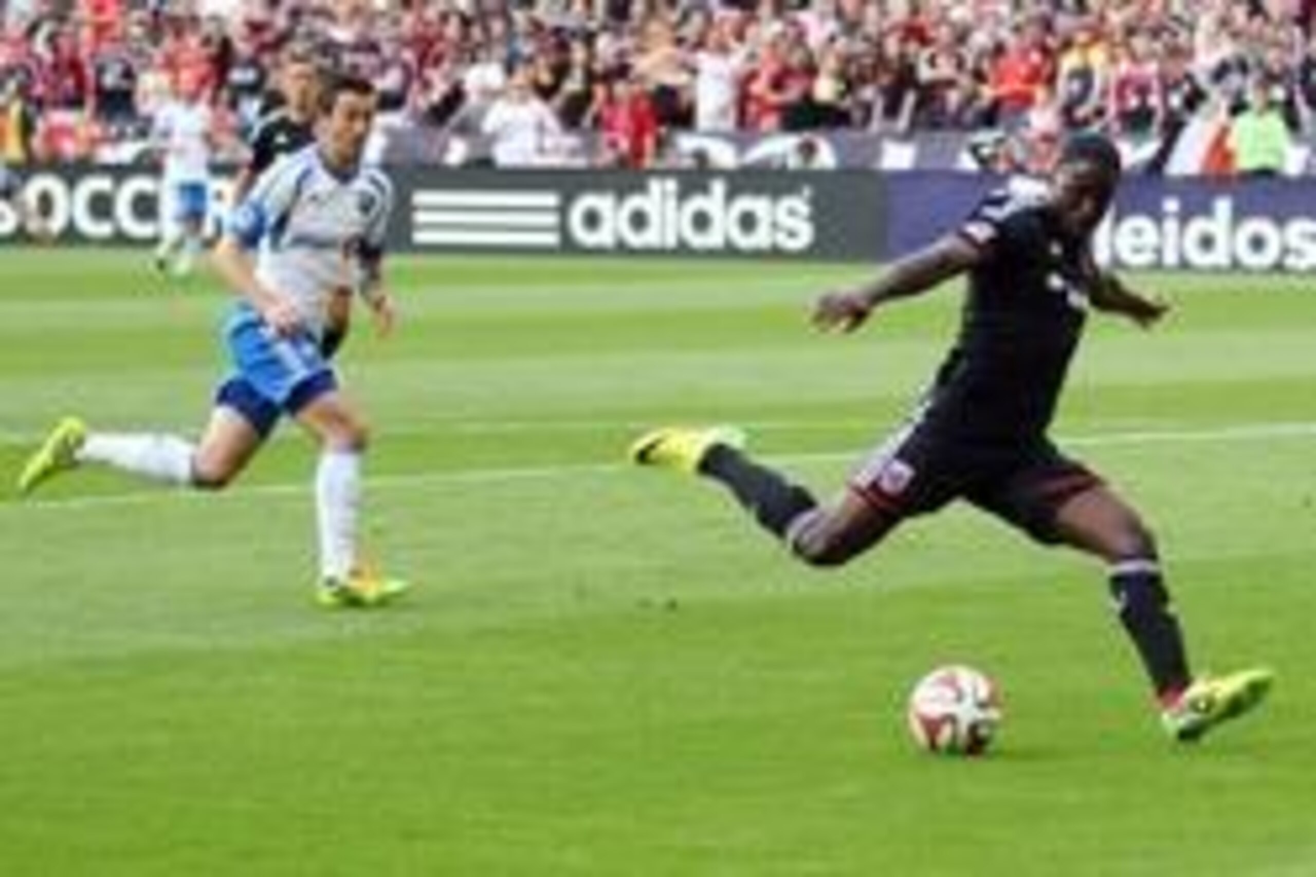 May 17, 2014; Washington, DC, USA; D.C. United forward Eddie Johnson (7) shoots the ball in front of Montreal Impact defender Wandrille Lefevre (55) in the first half at Robert F. Kennedy Memorial. Mandatory Credit: Geoff Burke-USA TODAY Sports