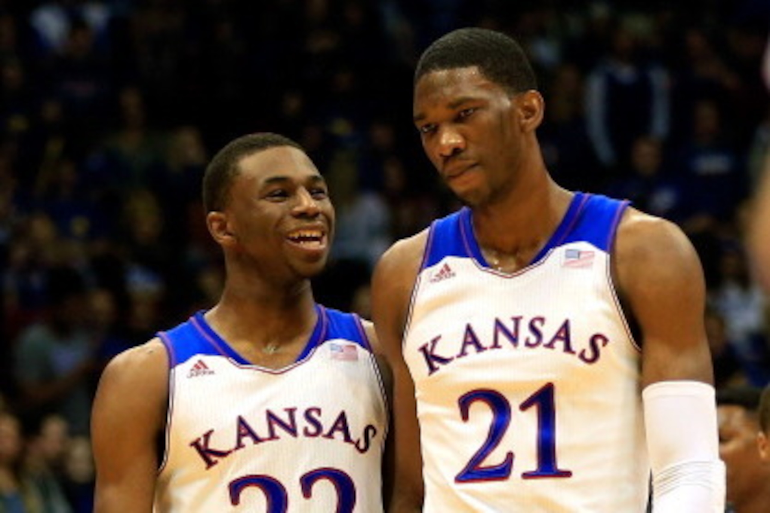 LAWRENCE, KS - NOVEMBER 22: Andrew Wiggins #22 of the Kansas Jayhawks talks with Joel Embiid #21 as they walk onto the floor after a timeout during the game against the Towson Tigers at Allen Fieldhouse on November 22, 2013 in Lawrence, Kansas. (Photo by 