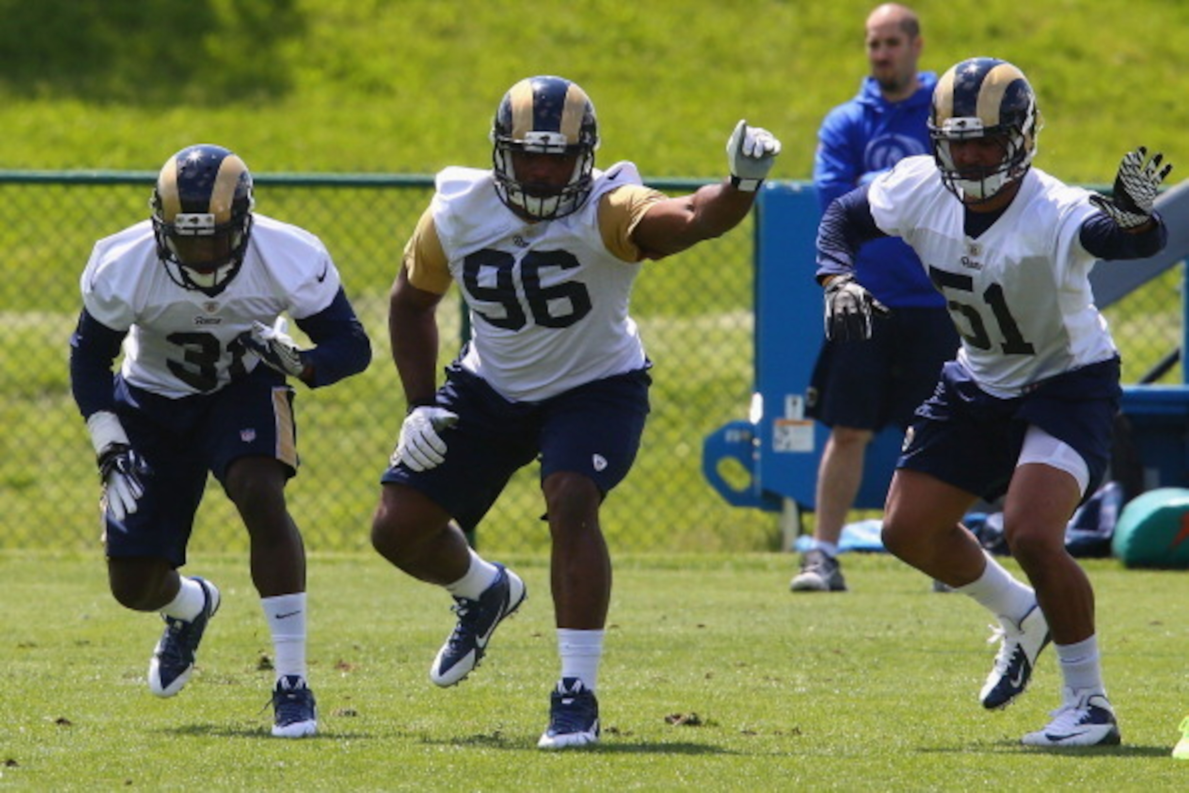 EARTH CITY, MO - MAY 16: Michael Sam #96, Maurice Alexander #31and Aaron Hill #51 of the St. Louis Rams participate in a rookie minicamp at Rams Park on May 16, 2014 in Earth City, Missouri.  (Photo by Dilip Vishwanat/Getty Images)