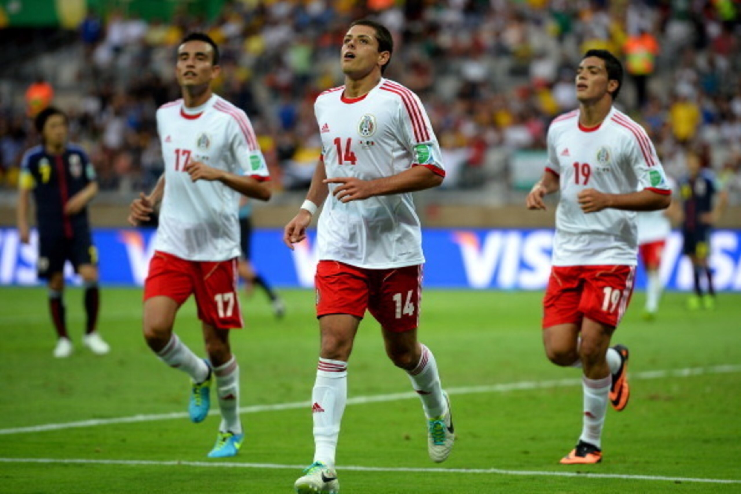 BELO HORIZONTE, BRAZIL - JUNE 22:  Javier Hernandez of Mexico celebrates one of his goals with his teammates Jesus Zavala and Raul Jimenez during the FIFA Confederations Cup Brazil 2013 Group A match between Japan and Mexico at Estadio Mineirao on June 22