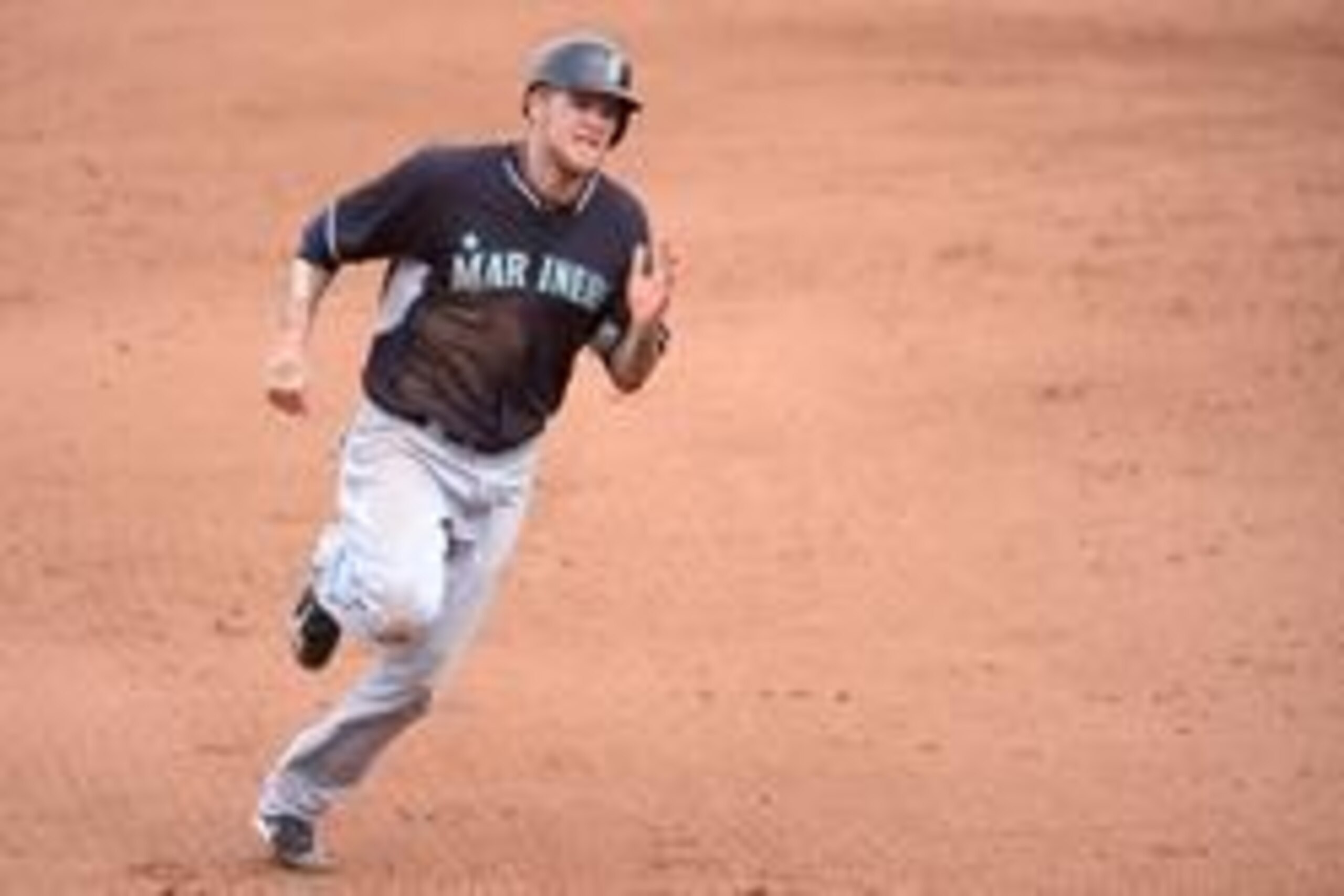 Mar 20, 2014; Mesa, AZ, USA; Seattle Mariners right fielder Corey Hart (27) runs to third base in the sixth inning against the Chicago Cubs at Cubs Park. The Mariners won 3-0. Mandatory Credit: Joe Camporeale-USA TODAY Sports