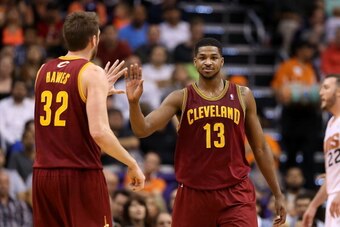 PHOENIX, AZ - MARCH 12:  Tristan Thompson #13 of the Cleveland Cavaliers high fives Spencer Hawes #32 after drawing a foul against the Phoenix Suns during the second half of the NBA game at US Airways Center on March 12, 2014 in Phoenix, Arizona. The Cava
