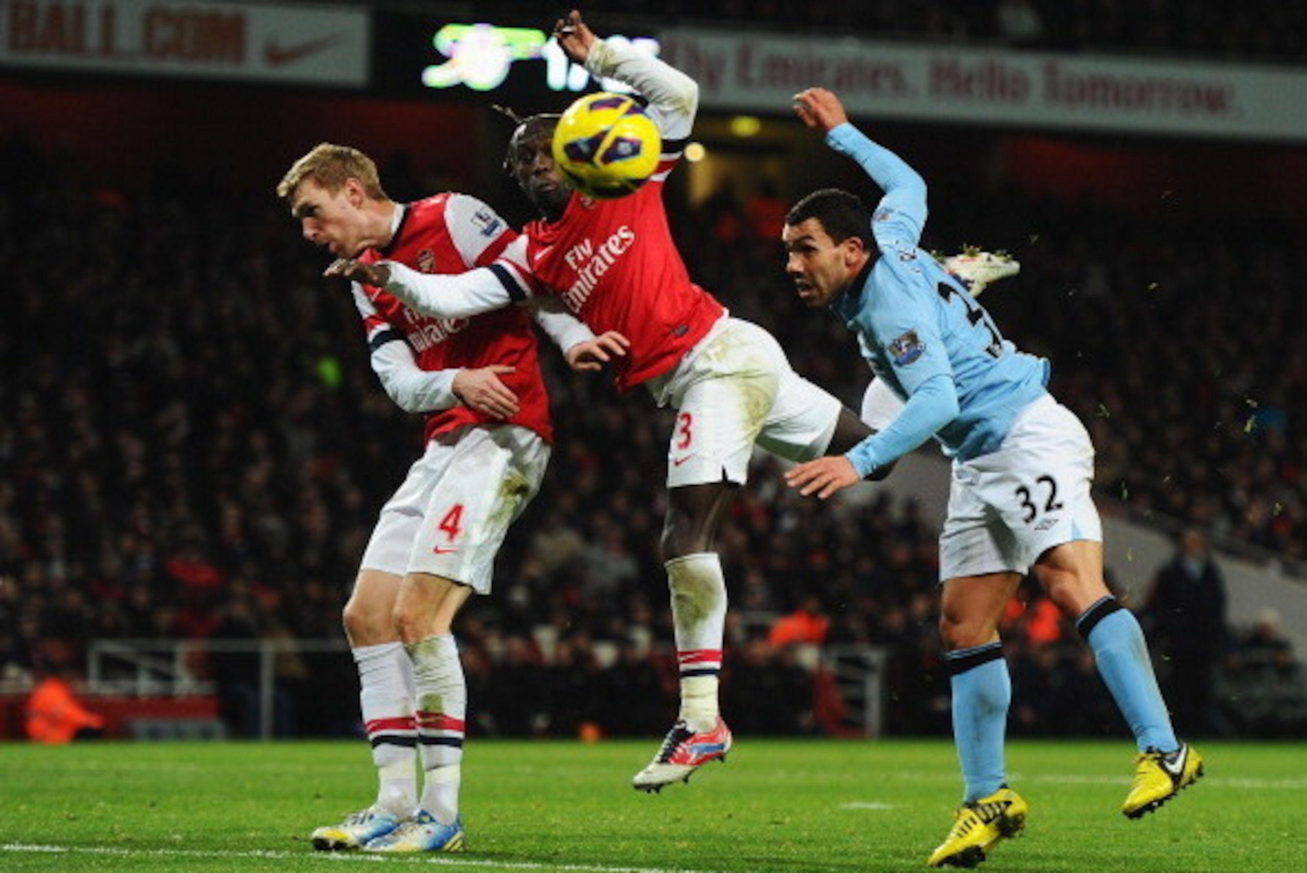 LONDON, ENGLAND - JANUARY 13:  (L-R) Per Mertesacker and Bacary Sagna of Arsenal foil Carlos Tevez of Manchester City during the Barclays Premier League match between Arsenal and Manchester City at Emirates Stadium on January 13, 2013 in London, England. 