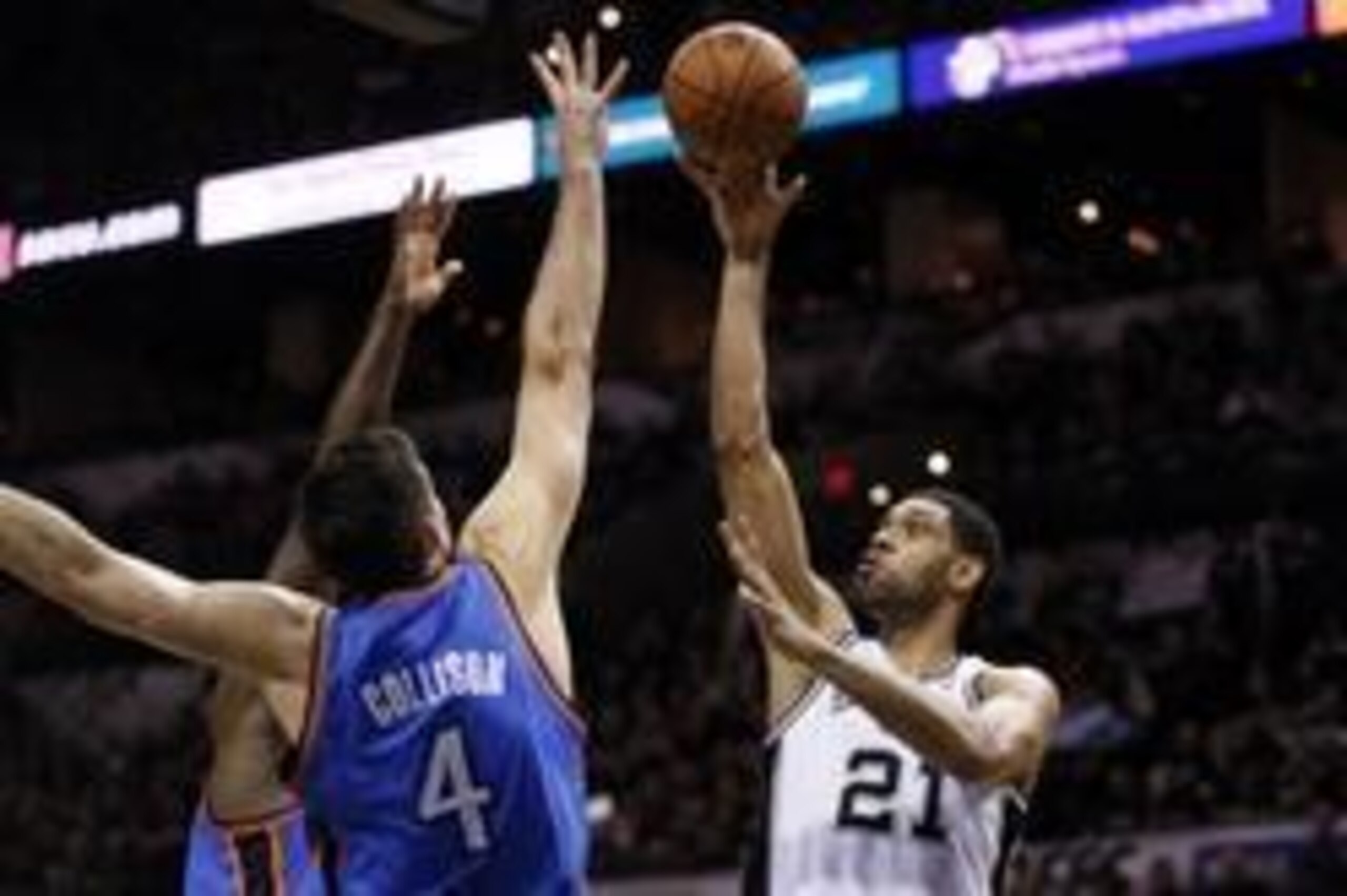 May 19, 2014; San Antonio, TX, USA; San Antonio Spurs forward Tim Duncan (21) shoots the ball over Oklahoma City Thunder forward Nick Collison (4) and center Kendrick Perkins (behind) in game one of the Western Conference Finals in the 2014 NBA Playoffs a