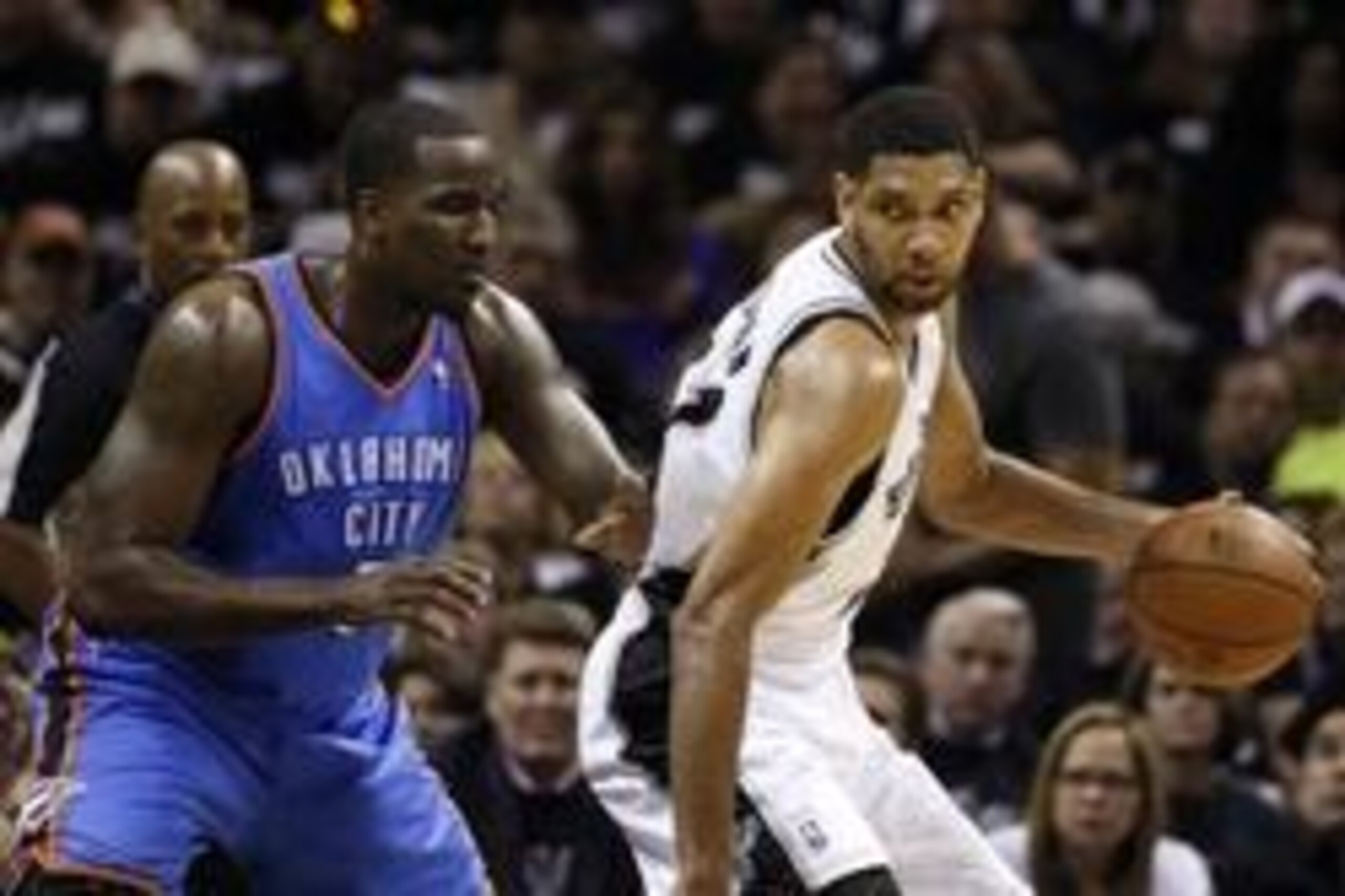 May 19, 2014; San Antonio, TX, USA; San Antonio Spurs forward Tim Duncan (right) posts up against Oklahoma City Thunder center Kendrick Perkins (left) in game one of the Western Conference Finals in the 2014 NBA Playoffs at AT&T Center. Mandatory Credit: 