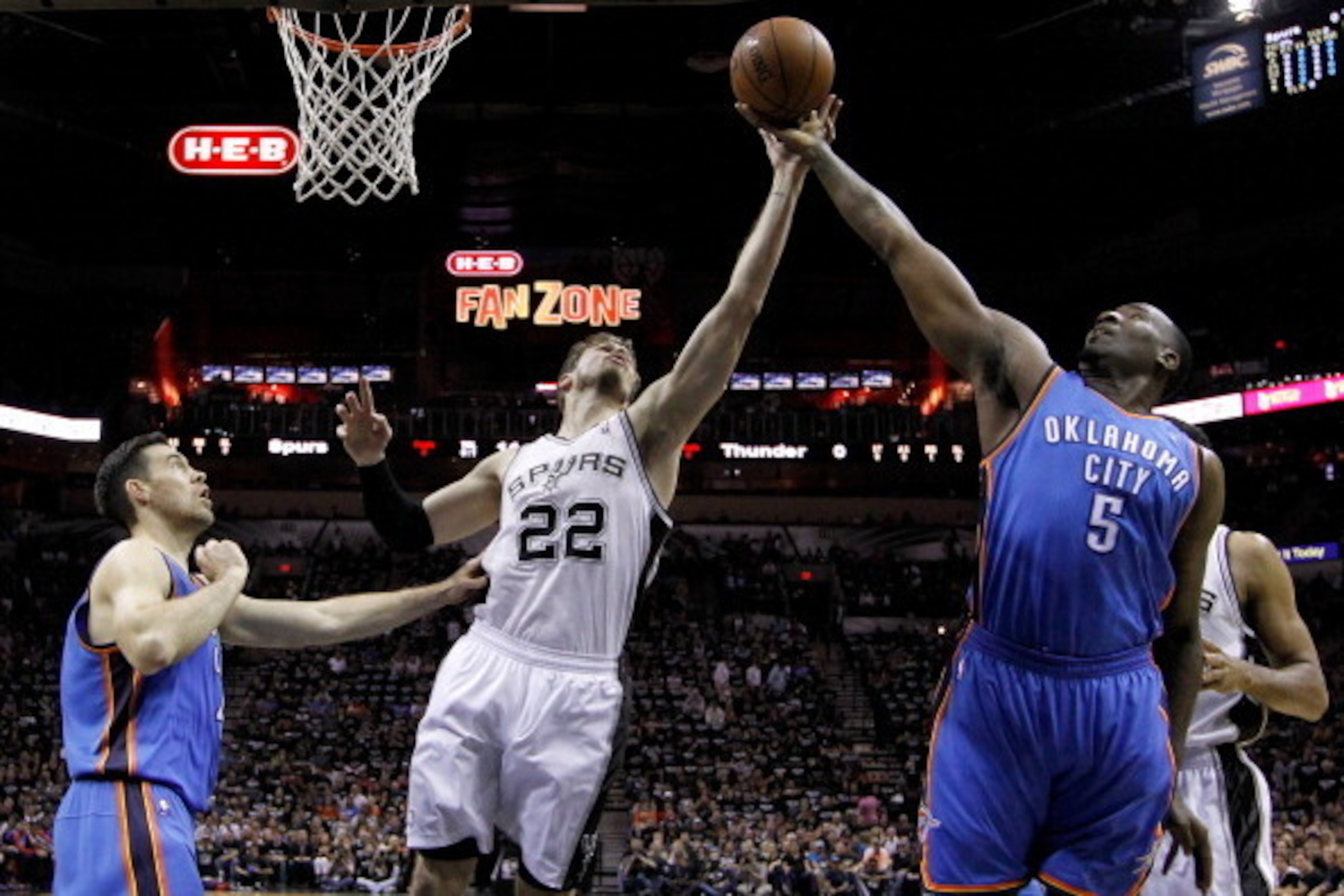 SAN ANTONIO, TX - MAY 19:  Tiago Splitter #22 of the San Antonio Spurs goes up for a rebound against Kendrick Perkins #5 of the Oklahoma City Thunder in the first half in Game One of the Western Conference Finals during the 2014 NBA Playoffs at AT&T Cente