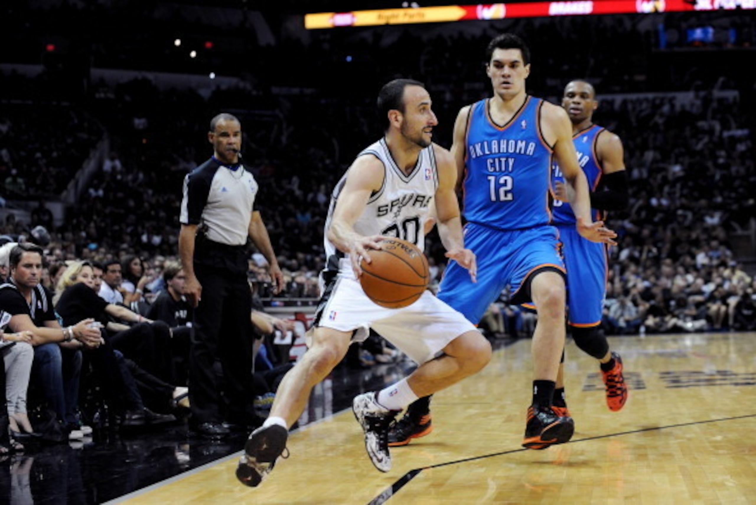 SAN ANTONIO, TX - MAY 19: Manu Ginobili #20 of the San Antonio Spurs drives against Steven Adams #12 of the Oklahoma City Thunder in Game One of the Western Conference Finals during the 2014 NBA Playoffs on May 19, 2014 at the AT&T Center in San Antonio, 