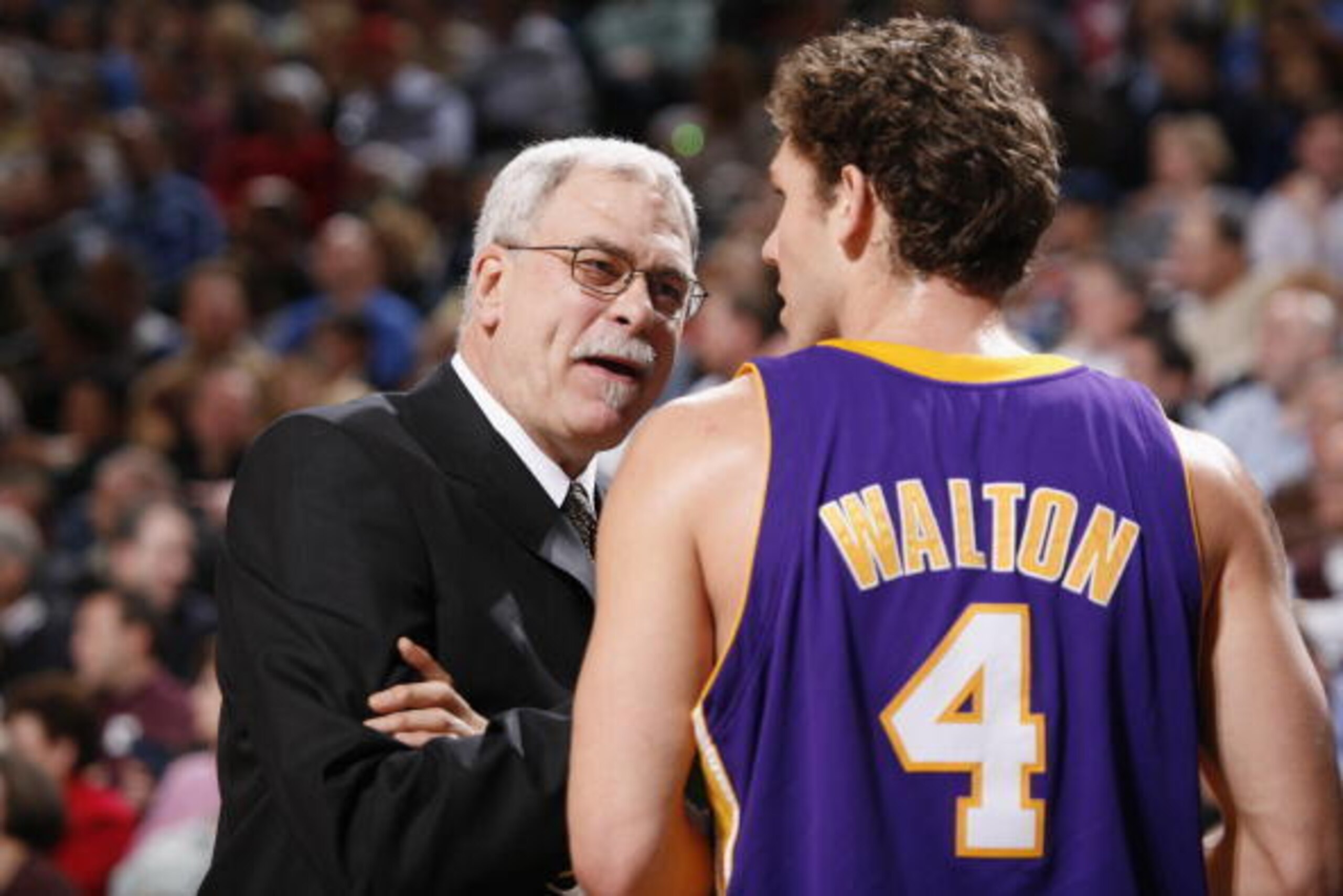 DALLAS - FEBRUARY 7:  Head coach Phil Jackson of the Los Angeles Lakers talks ot his teammate Luke Walton #4 during the game against the Dallas Mavericks at American Airlines Arena on February 7, 2006 in Dallas, Texas.  The Mavericks won 102-87.  NOTE TO 