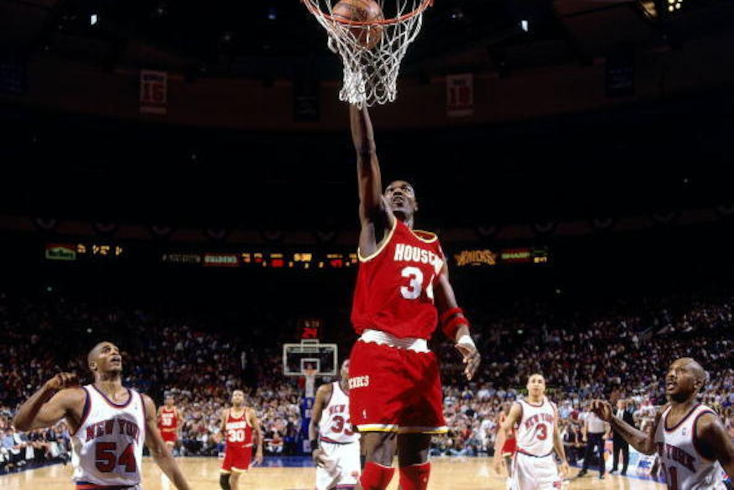 NEW YORK - JUNE 17:  Hakeem Olajuwon #34 of the Houston Rockets shoots a layup against Charles Smith #54 of the New York Knicks during Game Five of the NBA Finals played on June 17, 1994 at Madison Square Garden in New York, New York.  NOTE TO USER: User 