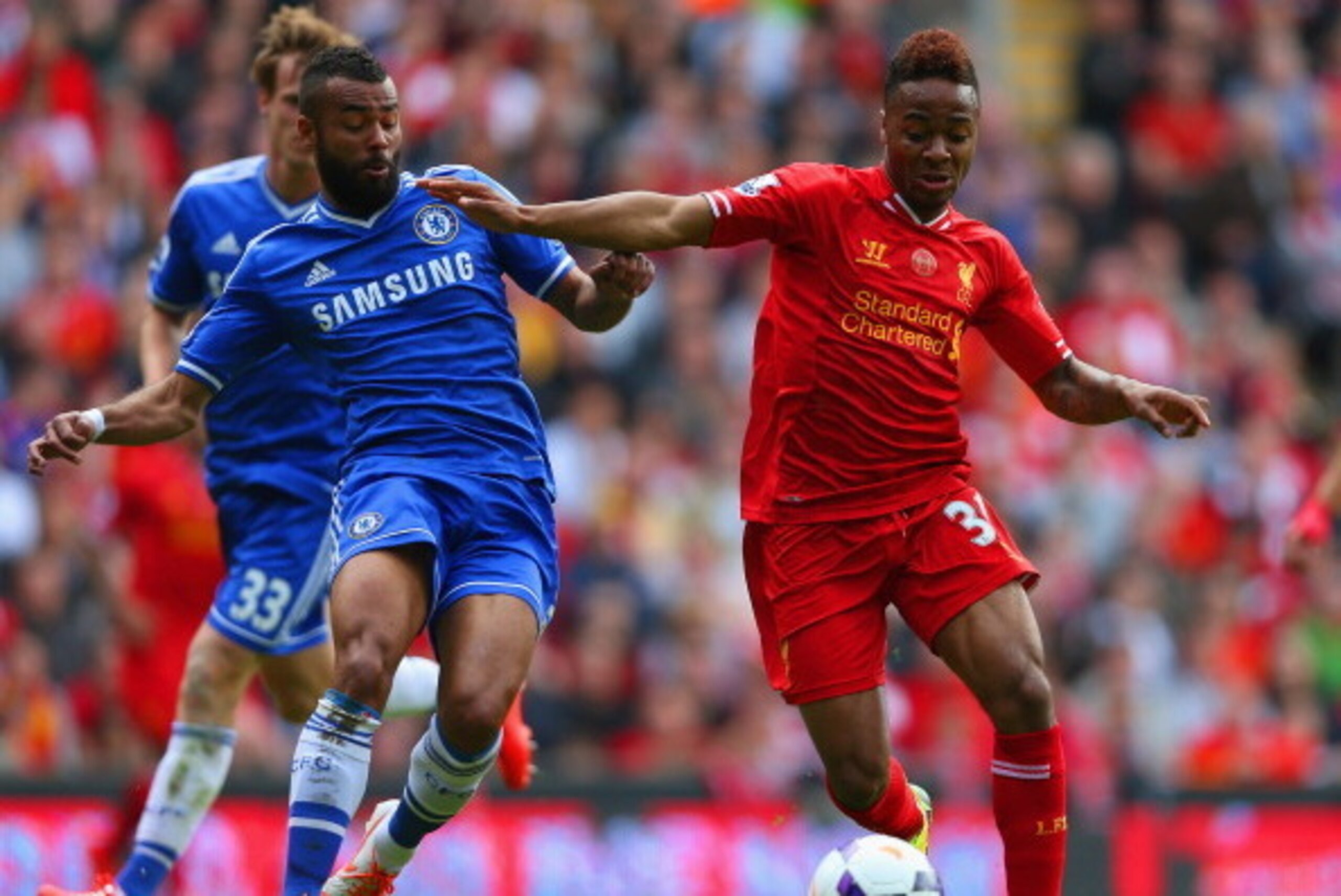 LIVERPOOL, ENGLAND - APRIL 27: Ashley Cole of Chelsea and Raheem Sterling of Liverpool battle for the ball during the Barclays Premier League match between Liverpool and Chelsea at Anfield on April 27, 2014 in Liverpool, England.  (Photo by Clive Brunskil
