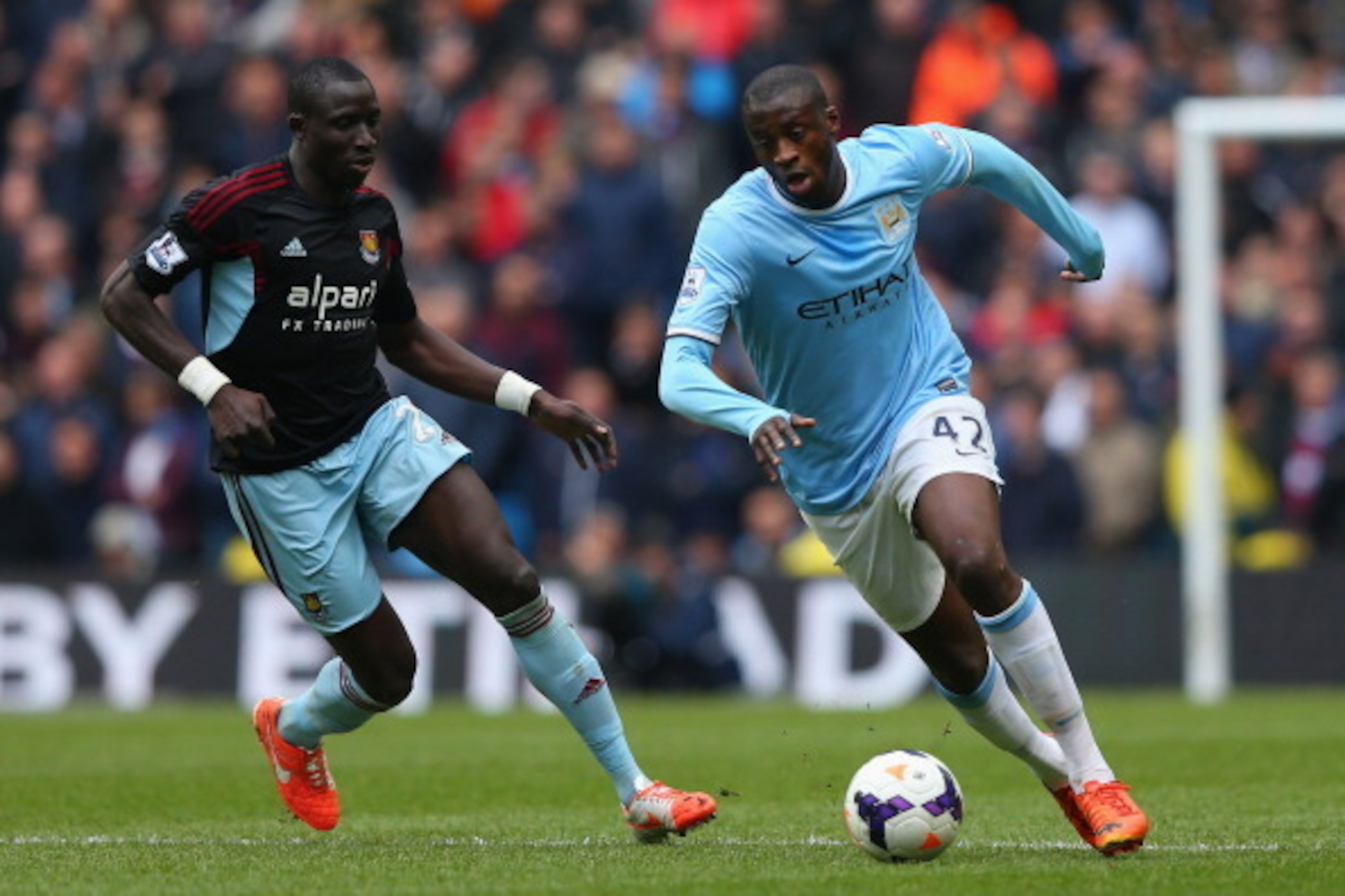 MANCHESTER, ENGLAND - MAY 11:  Yaya Toure of Manchester City competes with Mohamed Diame of West Ham United during the Barclays Premier League match between Manchester City and West Ham United at the Etihad Stadium on May 11, 2014 in Manchester, England. 