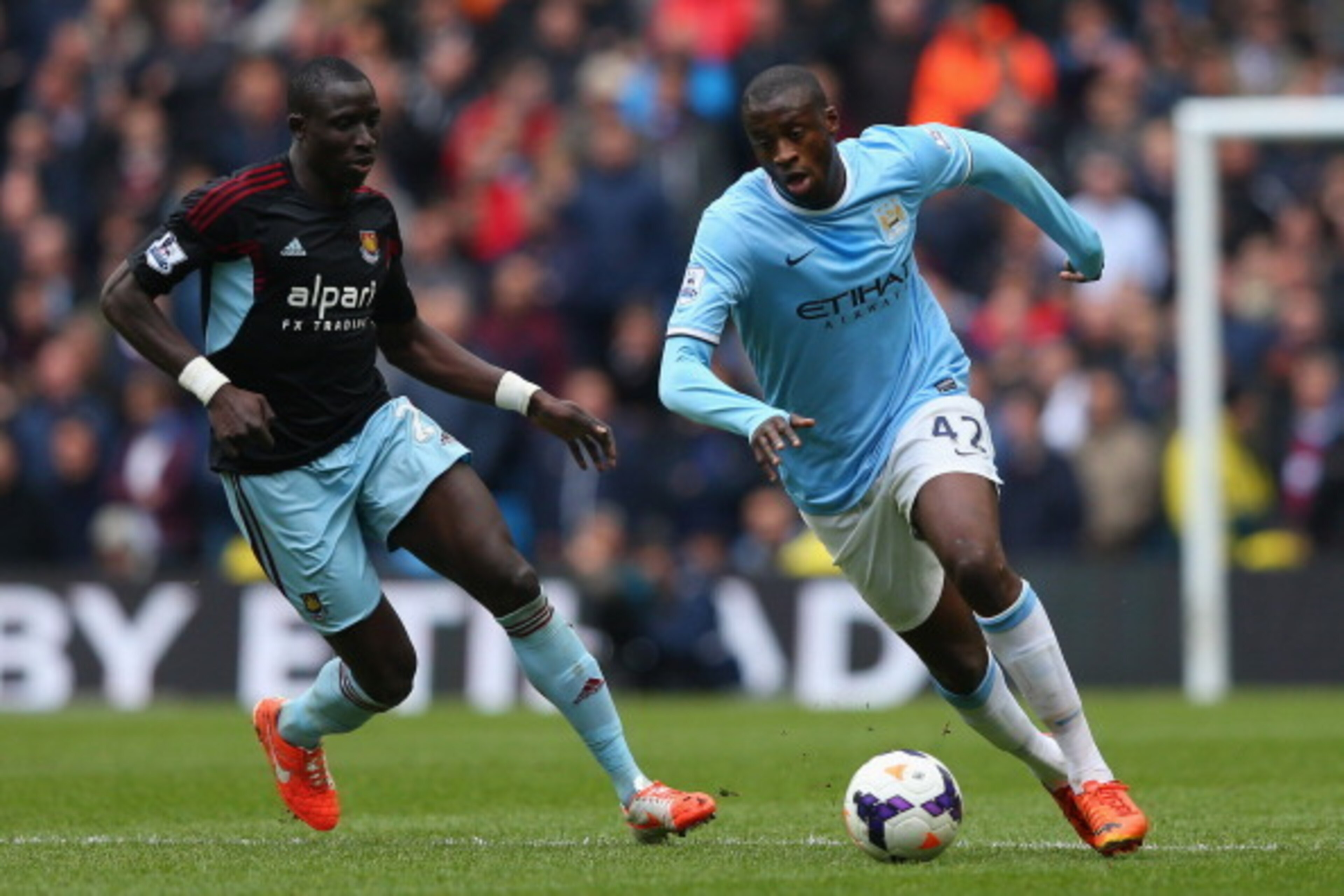 MANCHESTER, ENGLAND - MAY 11:  Yaya Toure of Manchester City competes with Mohamed Diame of West Ham United during the Barclays Premier League match between Manchester City and West Ham United at the Etihad Stadium on May 11, 2014 in Manchester, England. 