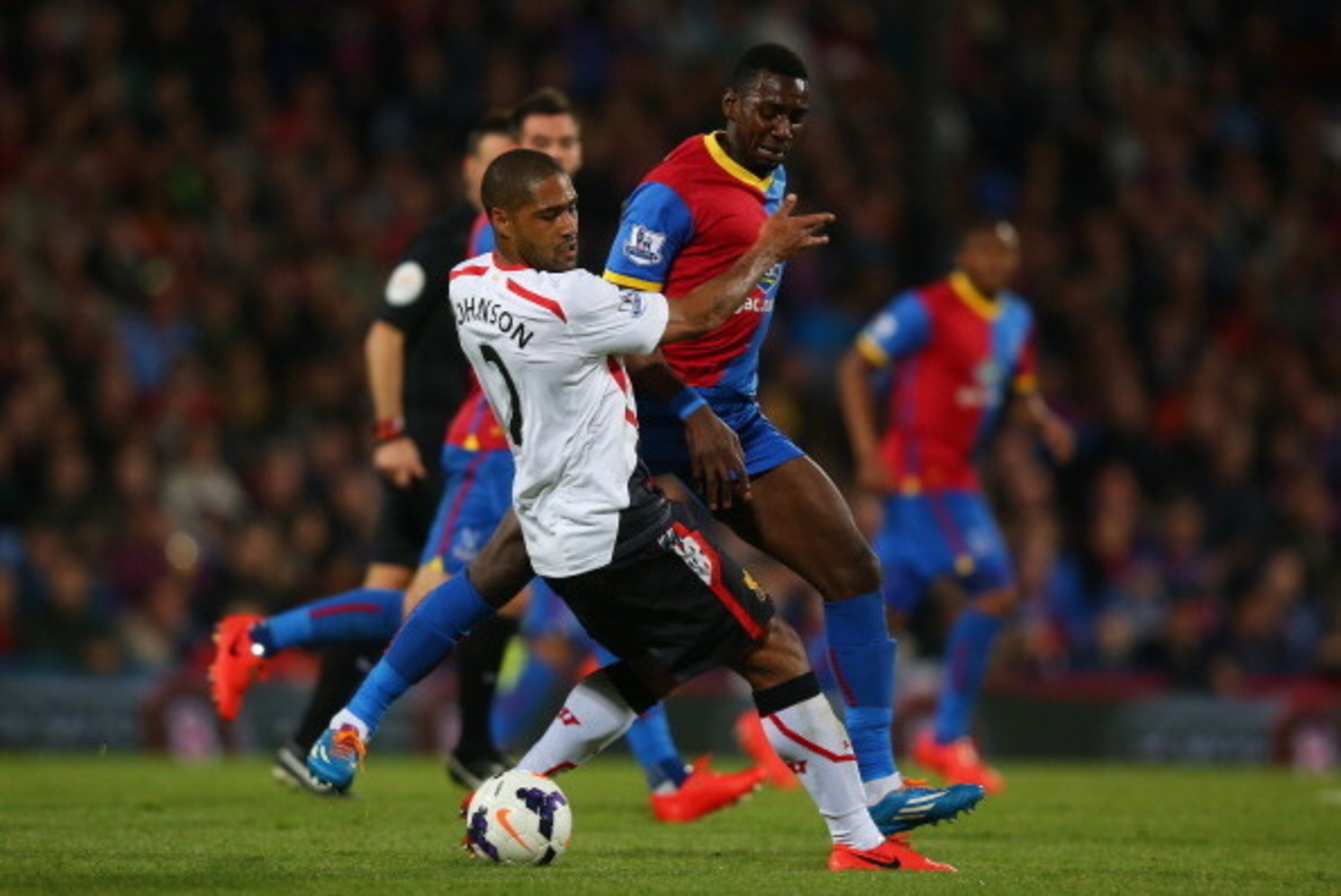 LONDON, ENGLAND - MAY 05:  Glen Johnson of Liverpool and Yannick Bolasie of Crystal Palace compete for the ball during the Barclays Premier League match between Crystal Palace and Liverpool at Selhurst Park on May 5, 2014 in London, England.  (Photo by Cl