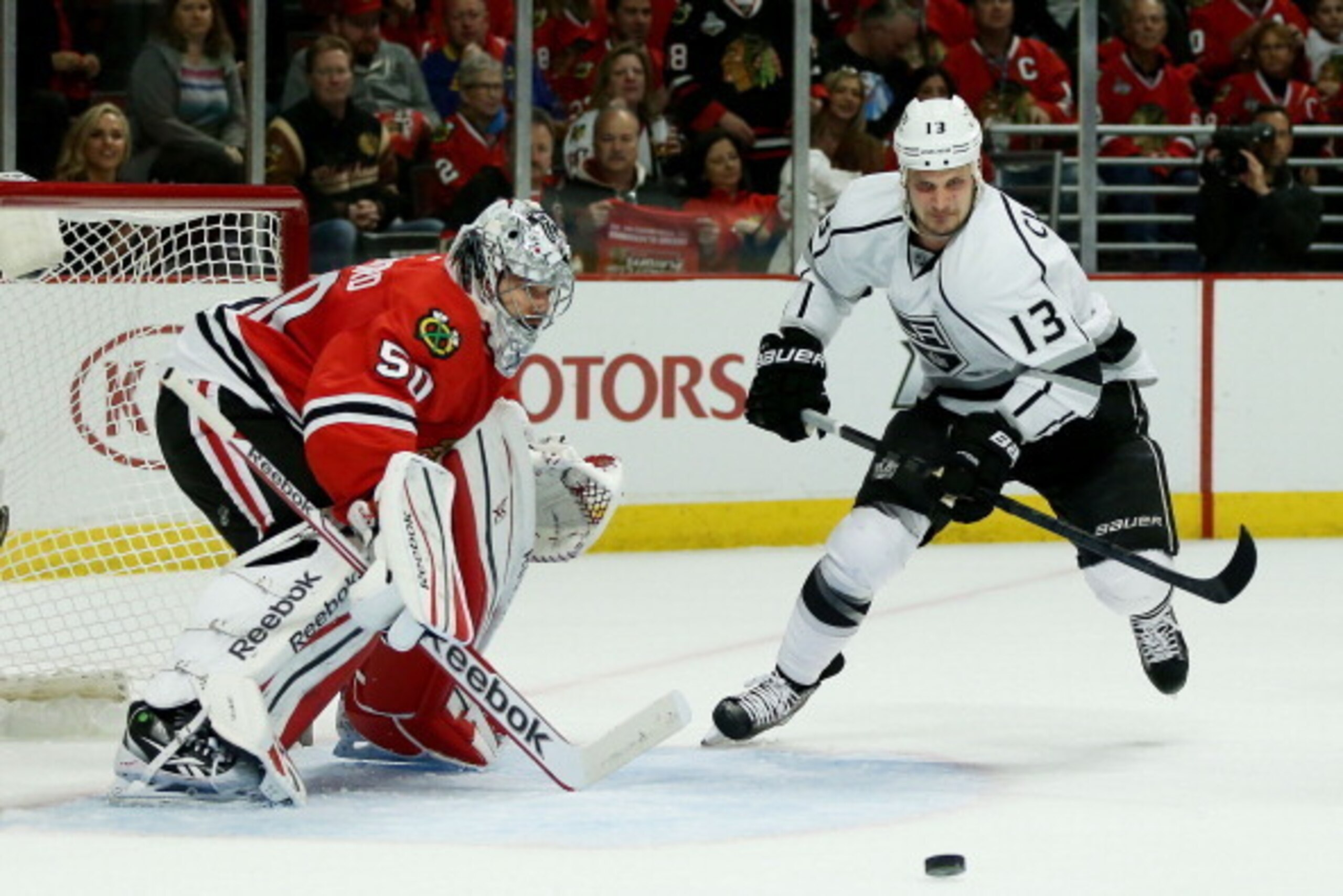CHICAGO, IL - MAY 18:  Corey Crawford #50 of the Chicago Blackhawks defends against Kyle Clifford #13 of the Los Angeles Kings in Game One of the Western Conference Final during the 2014 Stanley Cup Playoffs at United Center on May 18, 2014 in Chicago, Il