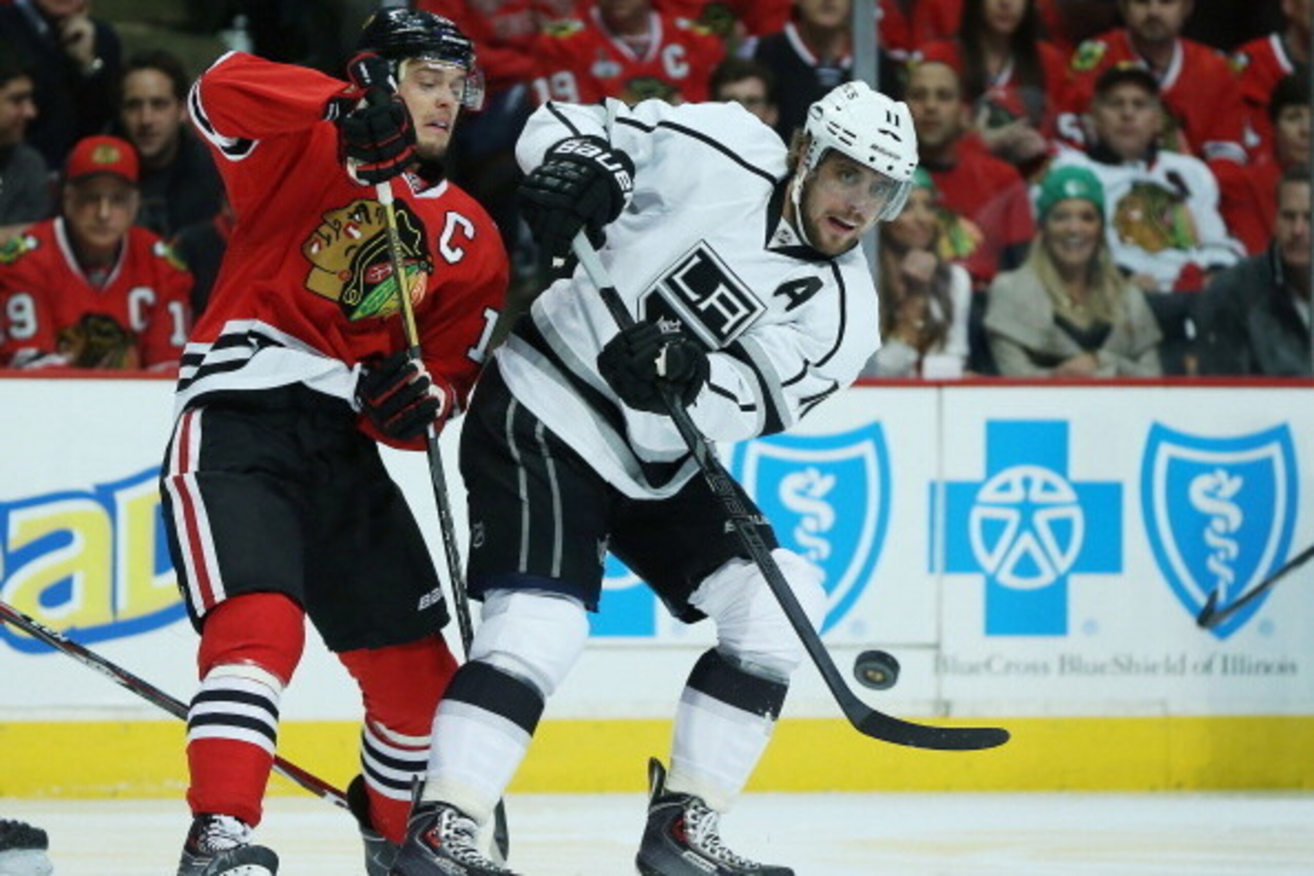 CHICAGO, IL - MAY 18:  Anze Kopitar #11 of the Los Angeles Kings controls the puck against the defense of Jonathan Toews #19 of the Chicago Blackhawks in the first period of Game One of the Western Conference Final during the 2014 Stanley Cup Playoffs at 