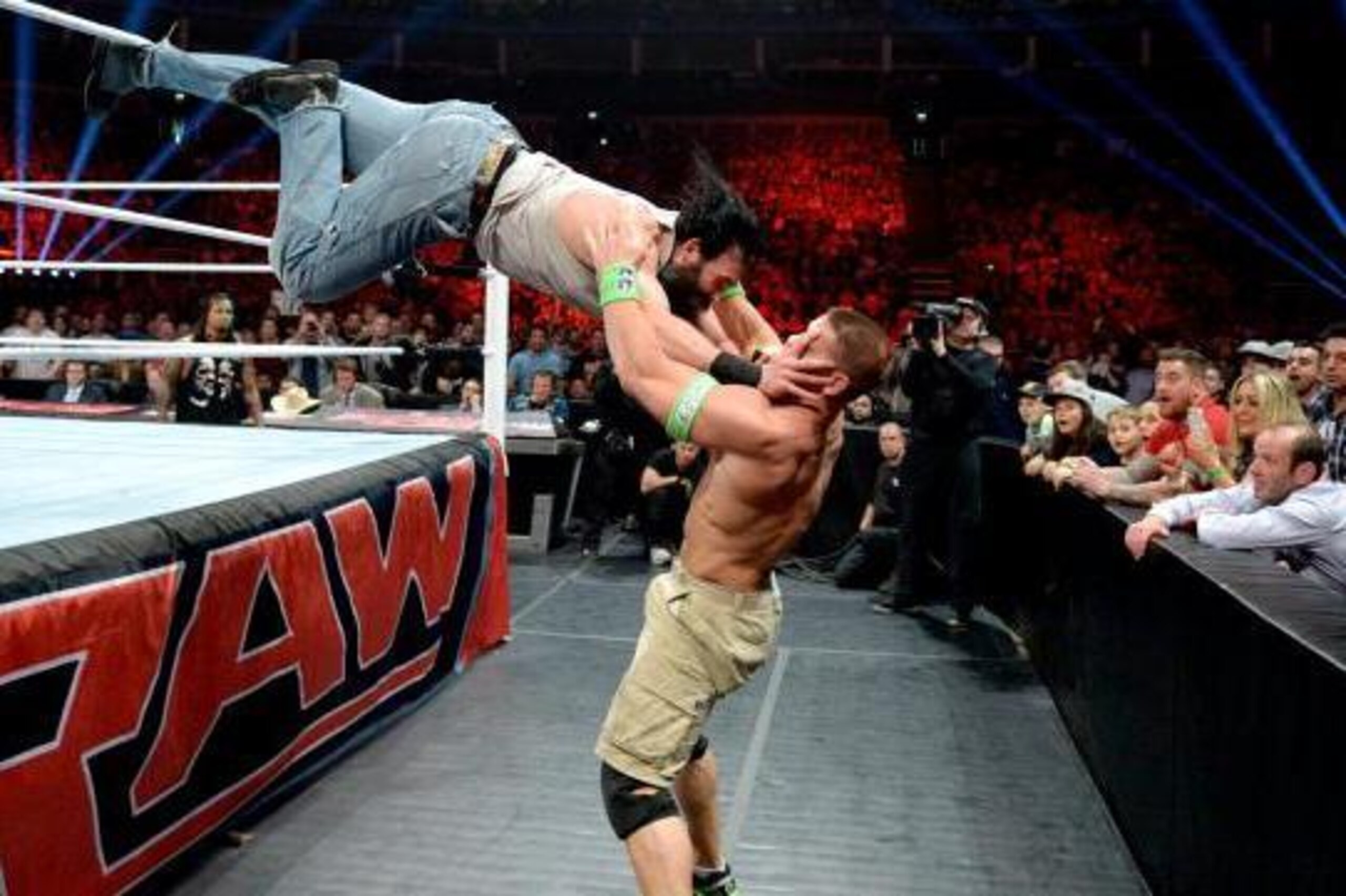 Luke Harper dives at John Cena. Luke Harper dives at John Cena.