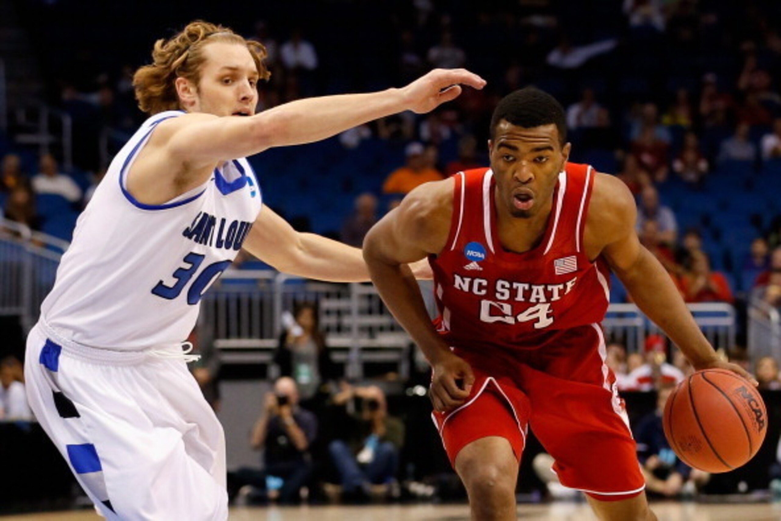 ORLANDO, FL - MARCH 20:  T.J. Warren #24 of the North Carolina State Wolfpack drives the ball against Jake Barnett #30 of the Saint Louis Billikens during the second round of the 2014 NCAA Men's Basketball Tournament at Amway Center on March 20, 2014 in O