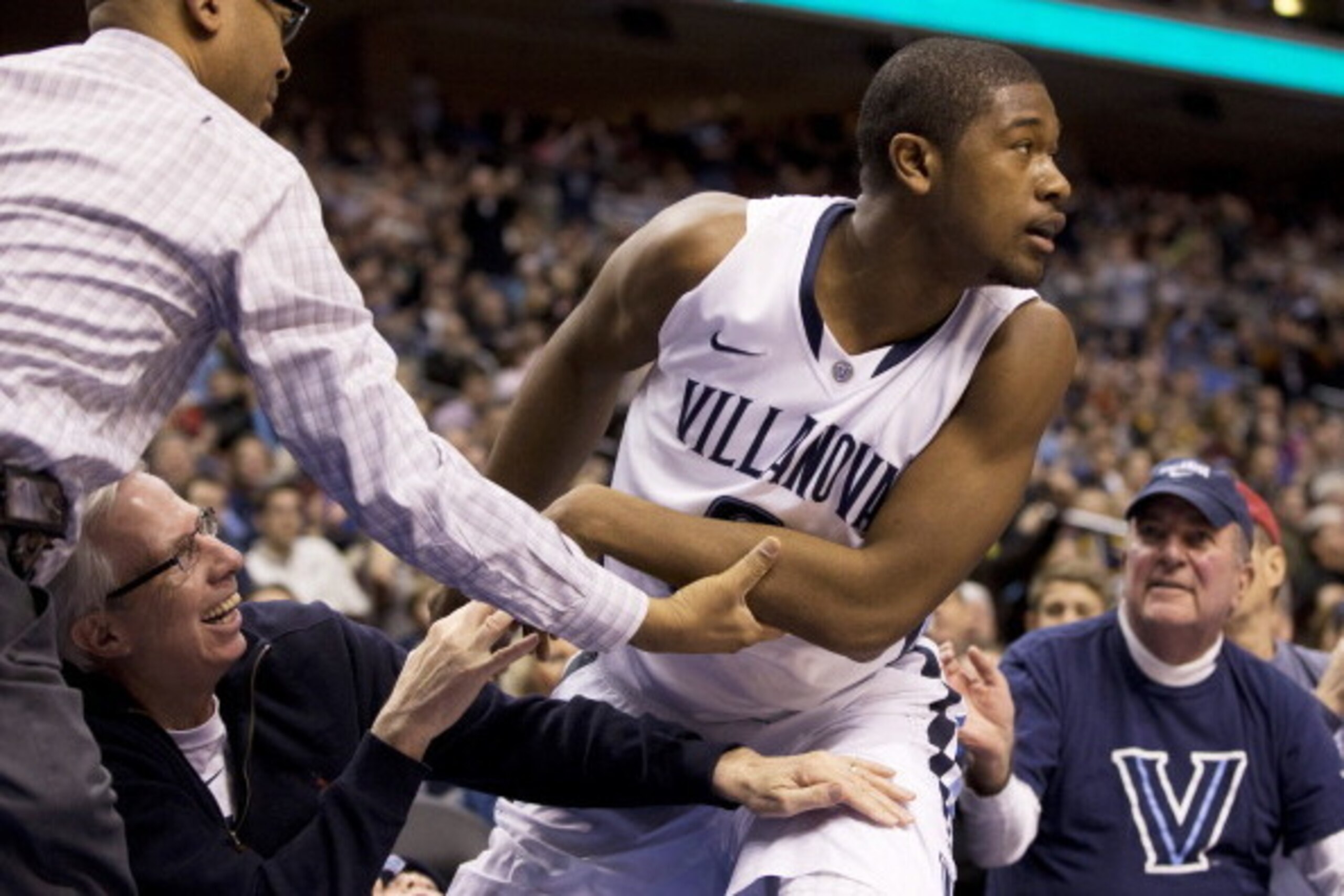 VILLANOVA, PA - MARCH 2: Forward Kris Jenkins #2 of the Villanova Wildcats falls into the stands during the game against the Marquetter Golden Eagles on March 2, 2014 at the Wells Fargo Center in Philadelphia, Pennslyvania. (Photo by Mitchell Leff/Getty I