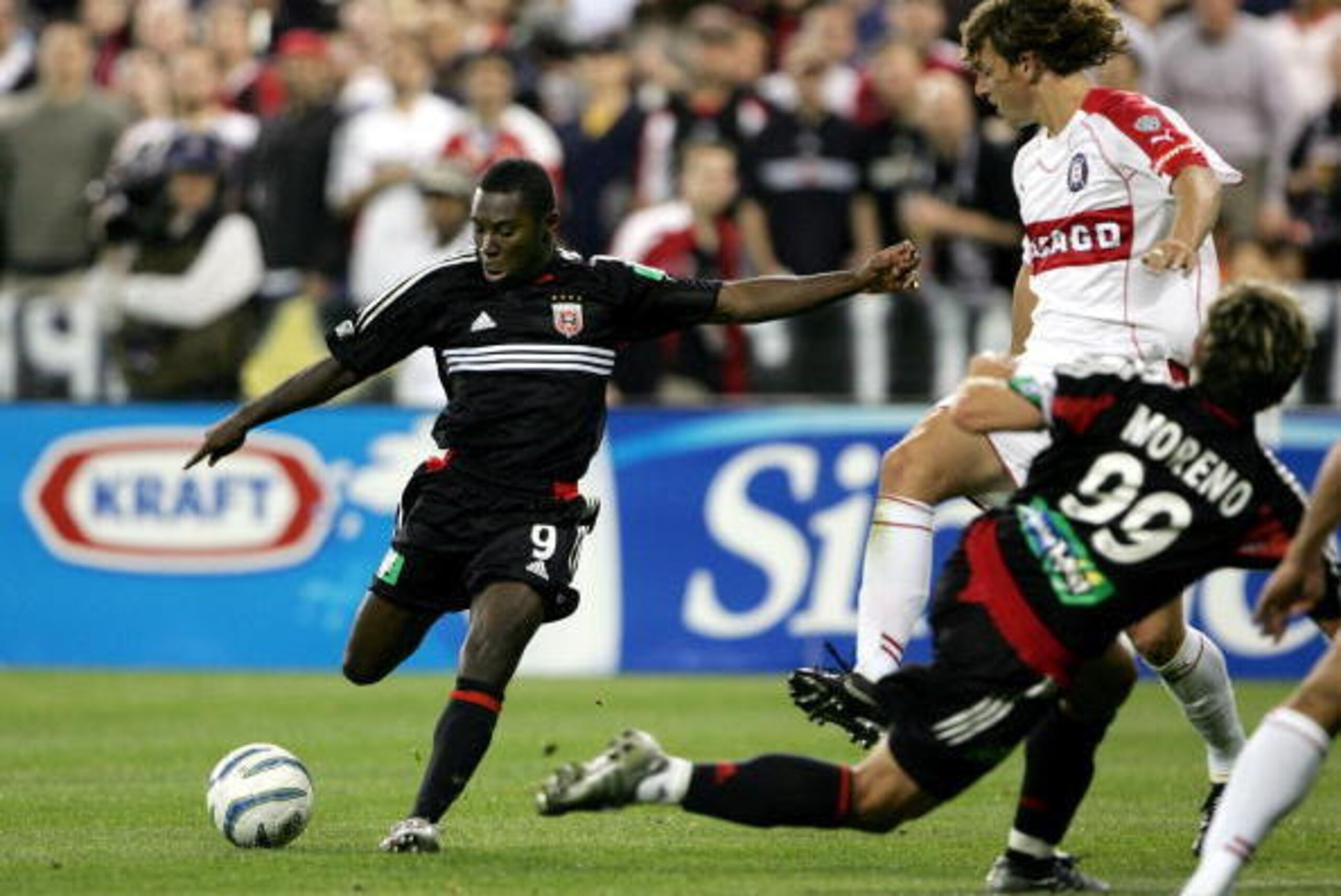 WASHINGTON - APRIL 09: Freddy Adu #9 of DC United takes a shot on goal past teammate Jaime Moreno #99 and Kelly Gray #6 of the Chicago Fire as DC United deteated the Fire 1-0 during MLS action at Robert F. Kennedy Stadium on April 9, 2005 in Washington, WASHINGTON - APRIL 09: Freddy Adu #9 of DC United takes a shot on goal past teammate Jaime Moreno #99 and Kelly Gray #6 of the Chicago Fire as DC United deteated the Fire 1-0 during MLS action at Robert F. Kennedy Stadium on April 9, 2005 in Washington,