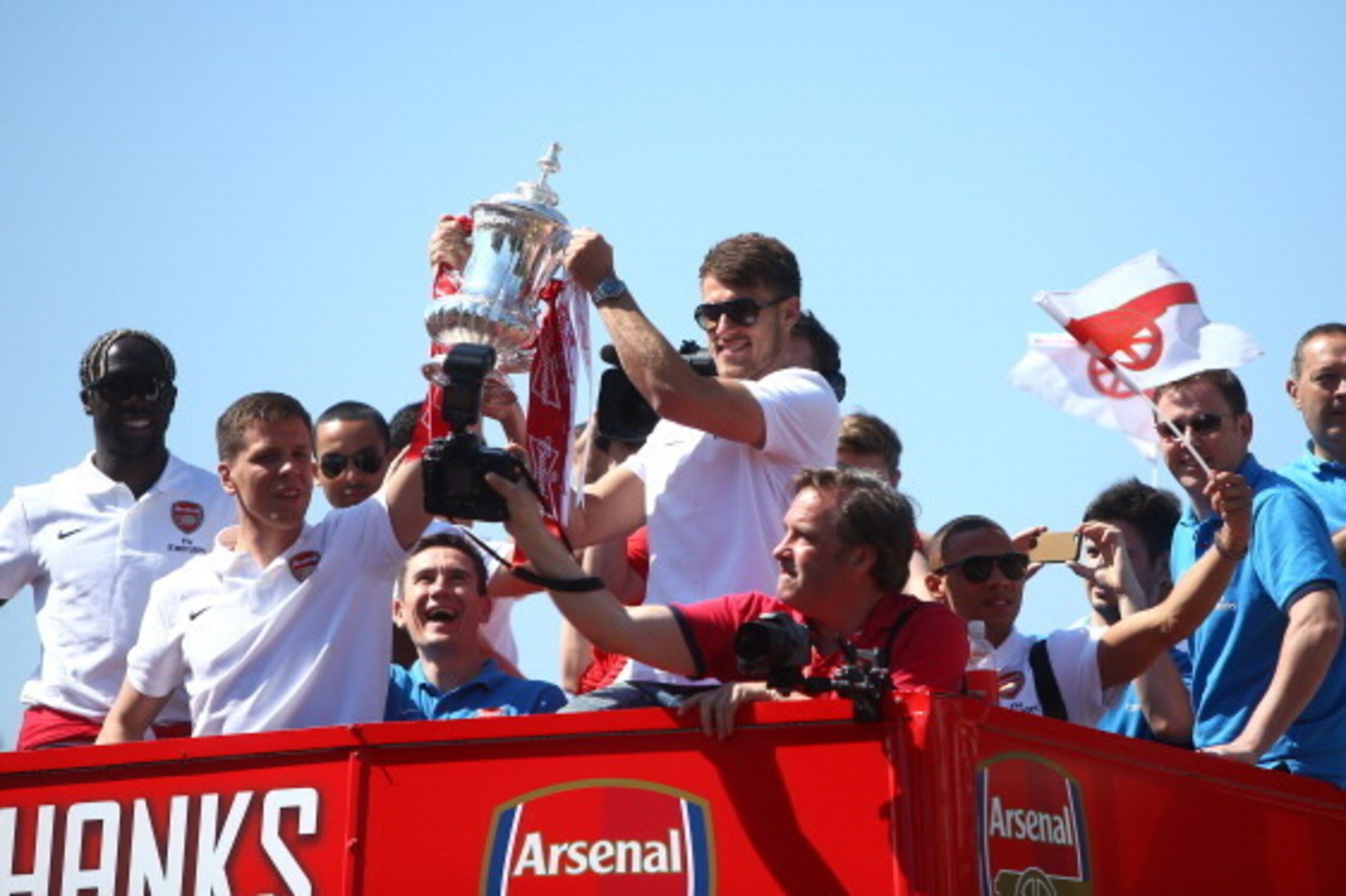 LONDON, ENGLAND - MAY 18: Wojciech Szczesny and Aaron Ramsey of Arsenal lift the FA cup during the Arsenal FA Cup Victory Parade on May 18, 2014 in London, England, (Photo by Charlie Crowhurst/Getty Images)