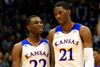 LAWRENCE, KS - NOVEMBER 22: Andrew Wiggins #22 of the Kansas Jayhawks talks with Joel Embiid #21 as they walk onto the floor after a timeout during the game against the Towson Tigers at Allen Fieldhouse on November 22, 2013 in Lawrence, Kansas. (Photo by