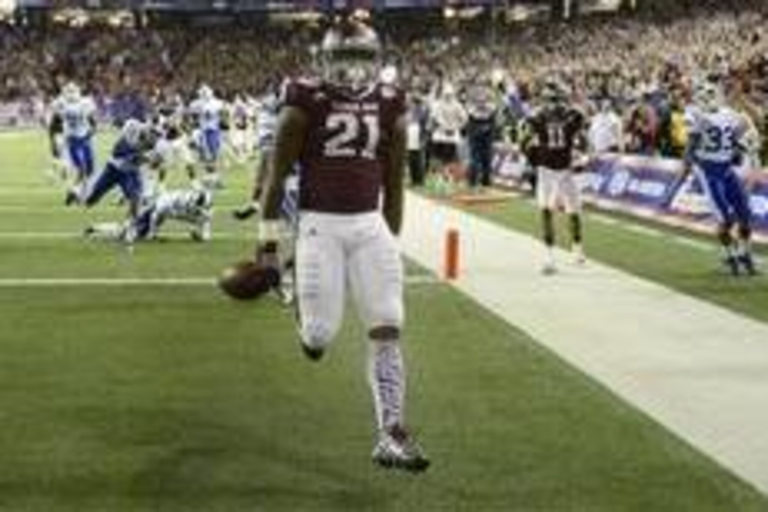 Dec 31, 2013; Atlanta, GA, USA; Texas A&M Aggies running back Tra Carson (21) scores a touchdown in the third quarter past Duke Blue Devils cornerback DeVon Edwards (27) safety Jeremy Cash (16) in the 2013 Chick-fil-a Bowl at the Georgia Dome. Mandatory C