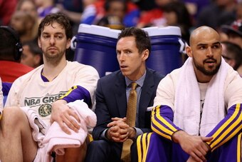 LOS ANGELES, CA - APRIL 07:  (L-R) Pau Gasol #16, Steve Nash #10 and Robert Sacre #50 of the Los Angeles Lakers watch from the bench during the NBA game against the Los Angeles Clippers at Staples Center on April 7, 2013 in Los Angeles, California.  The C