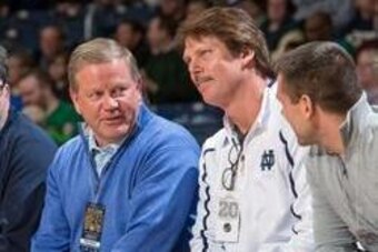 Feb 26, 2014; South Bend, IN, USA; Notre Dame Fighting Irish head football coach Brian Kelly and defensive coordinator Brian VanGorder watch the basketball game between the Notre Dame Fighting Irish and the Georgia Tech Yellow Jackets at the Purcell Pavil