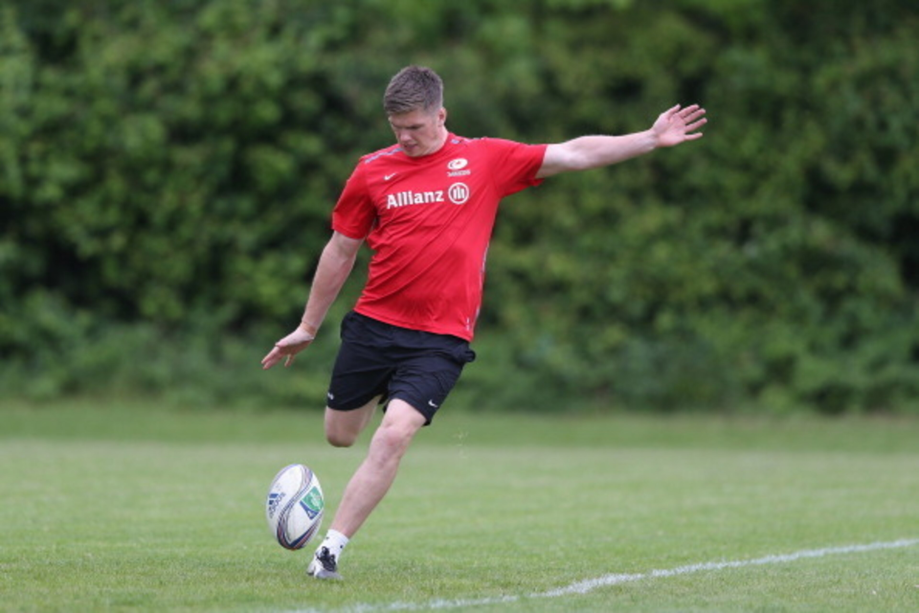 ST ALBANS, ENGLAND - MAY 20:  Owen Farrell kicks the ball upfield during the Saracens training session on May 20, 2014 in St Albans, England.  (Photo by David Rogers/Getty Images)