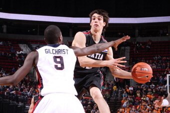 PORTLAND, OR - APRIL 9: Dario Saric #12 of the World Select Team passes against Michael Gilchrist #9 of the USA Junior National Select Team during the game on April 9, 2011 at the Rose Garden Arena in Portland, Oregon. NOTE TO USER: User expressly acknowl