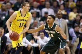 Mar 16, 2014; Indianapolis, IN, USA; Michigan Wolverines guard Nik Stauskas (11) is guarded by Michigan State Spartans guard Gary Harris (14) in the championship game for the Big Ten college basketball tournament at Bankers Life Fieldhouse. Mandatory Cred