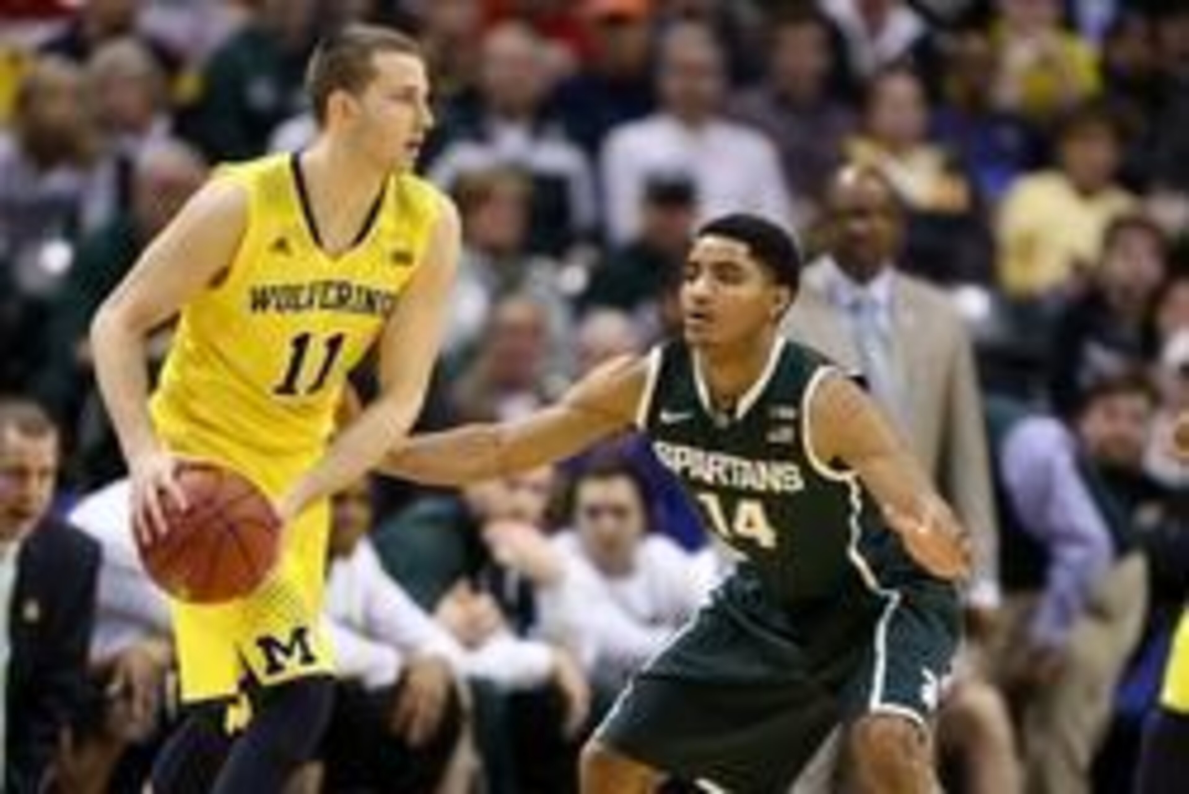Mar 16, 2014; Indianapolis, IN, USA; Michigan Wolverines guard Nik Stauskas (11) is guarded by Michigan State Spartans guard Gary Harris (14) in the championship game for the Big Ten college basketball tournament at Bankers Life Fieldhouse. Mandatory Cred