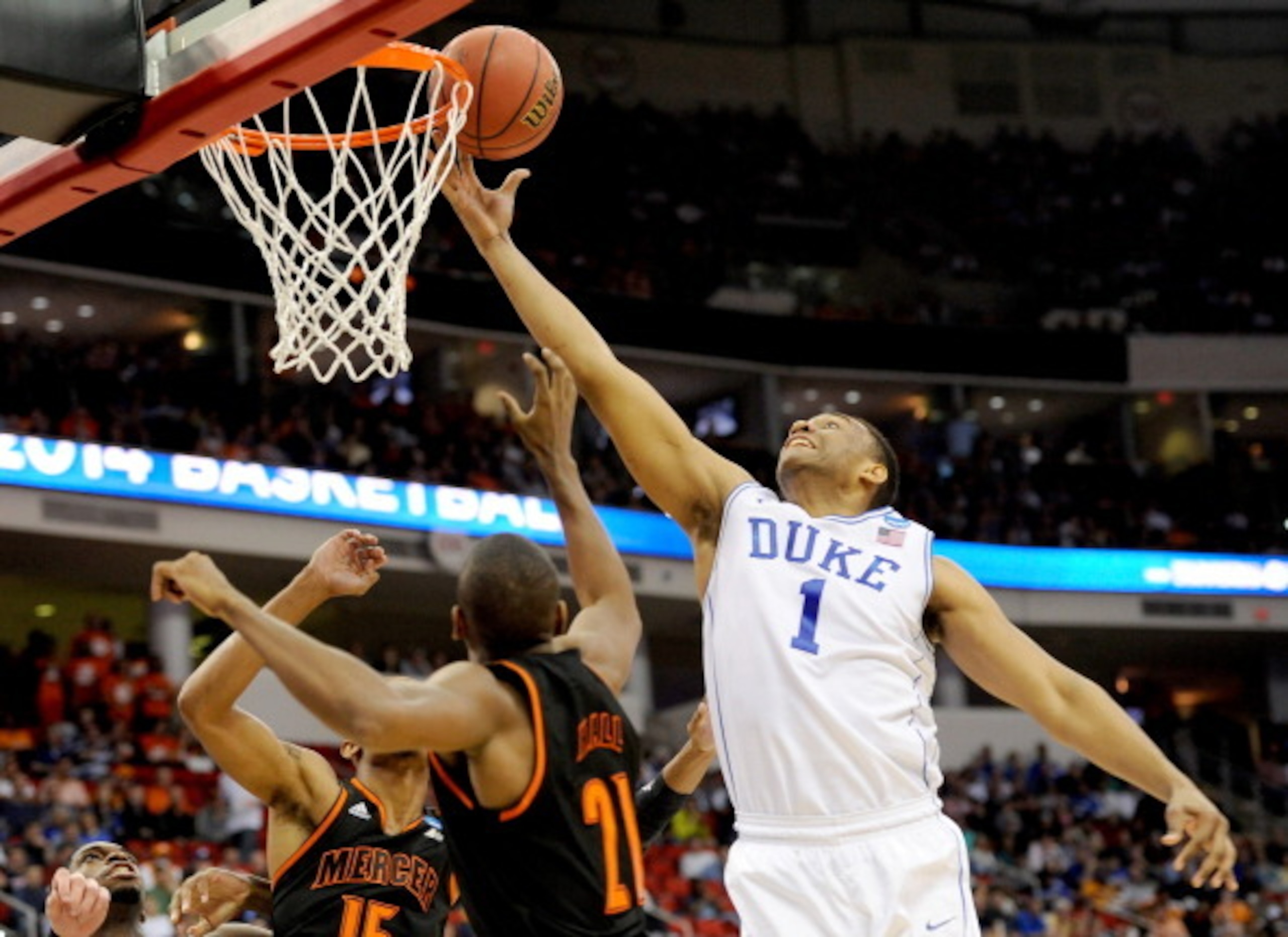 RALEIGH, NC - MARCH 21:  Jabari Parker #1 of the Duke Blue Devils goes up for the ball against Langston Hall #21 of the Mercer Bears in the first half in the second round of the 2014 NCAA Men's Basketball Tournament at PNC Arena on March 21, 2014 in Ralei