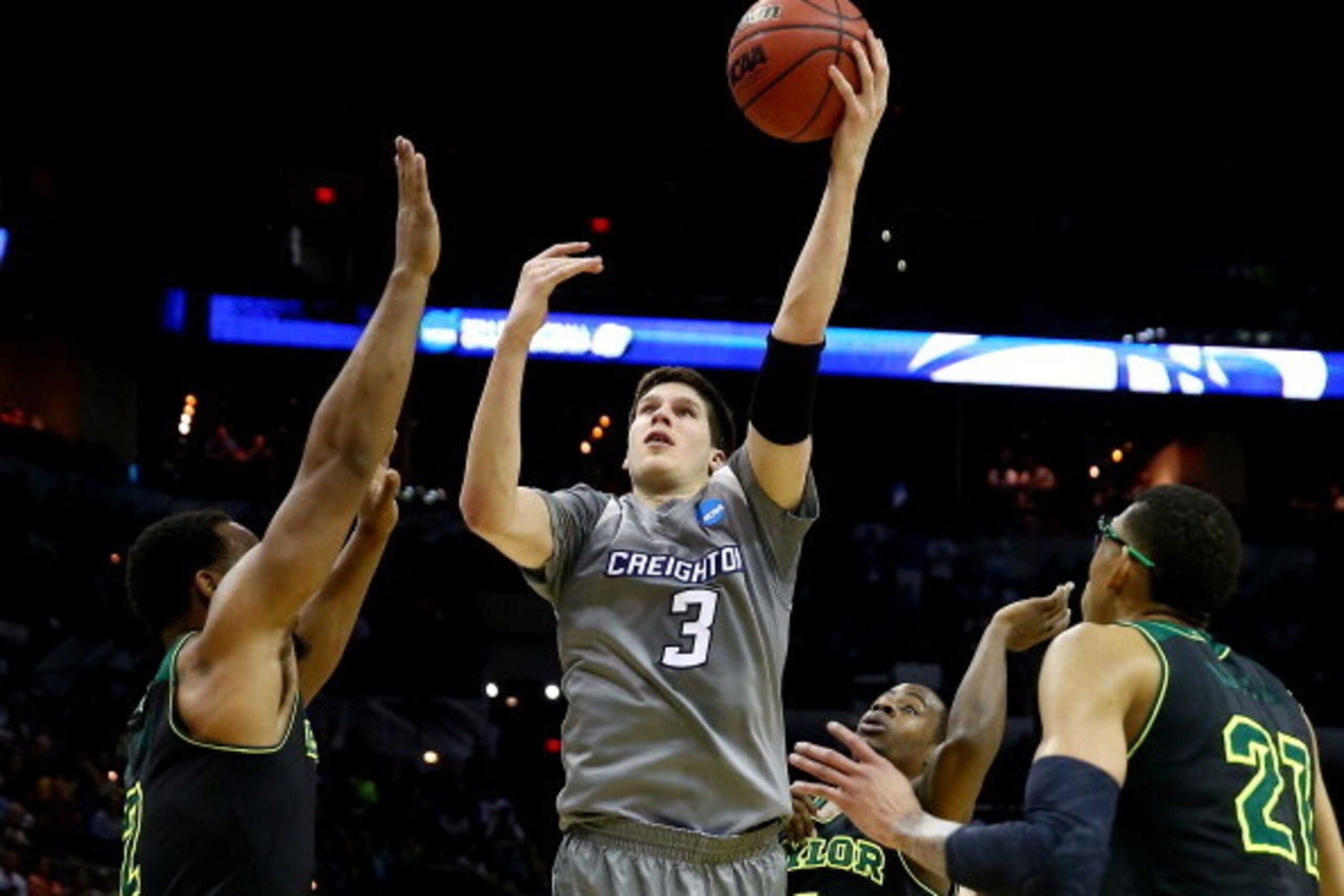 SAN ANTONIO, TX - MARCH 23:  Doug McDermott #3 of the Creighton Bluejays takes a shot as Rico Gathers #2 and Isaiah Austin #21 of the Baylor Bears defend during the third round of the 2014 NCAA Men's Basketball Tournament at the AT&T Center on March 23, 2