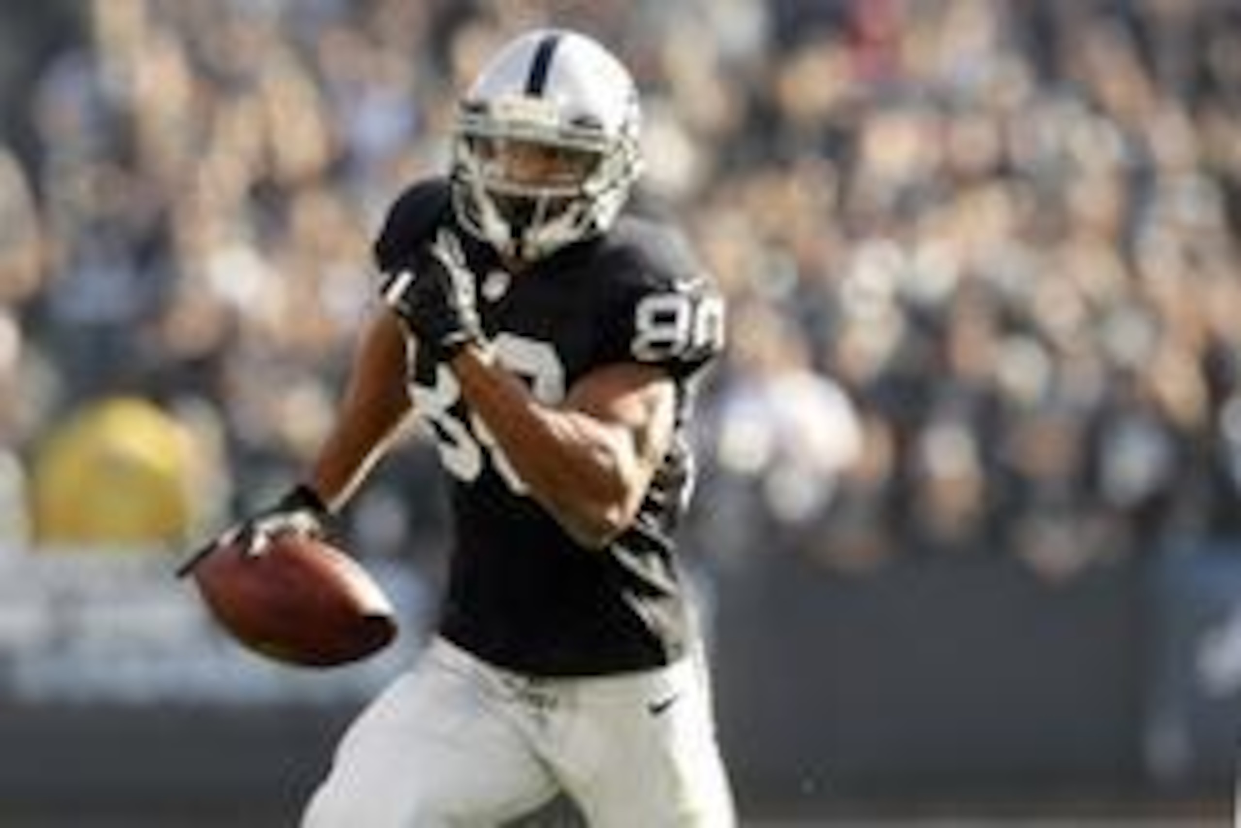 Dec 15, 2013; Oakland, CA, USA; Oakland Raiders wide receiver Rod Streater (80) runs with the ball after catching a pass against the Kansas City Chiefs in the first quarter at O.co Coliseum. Mandatory Credit: Cary Edmondson-USA TODAY Sports