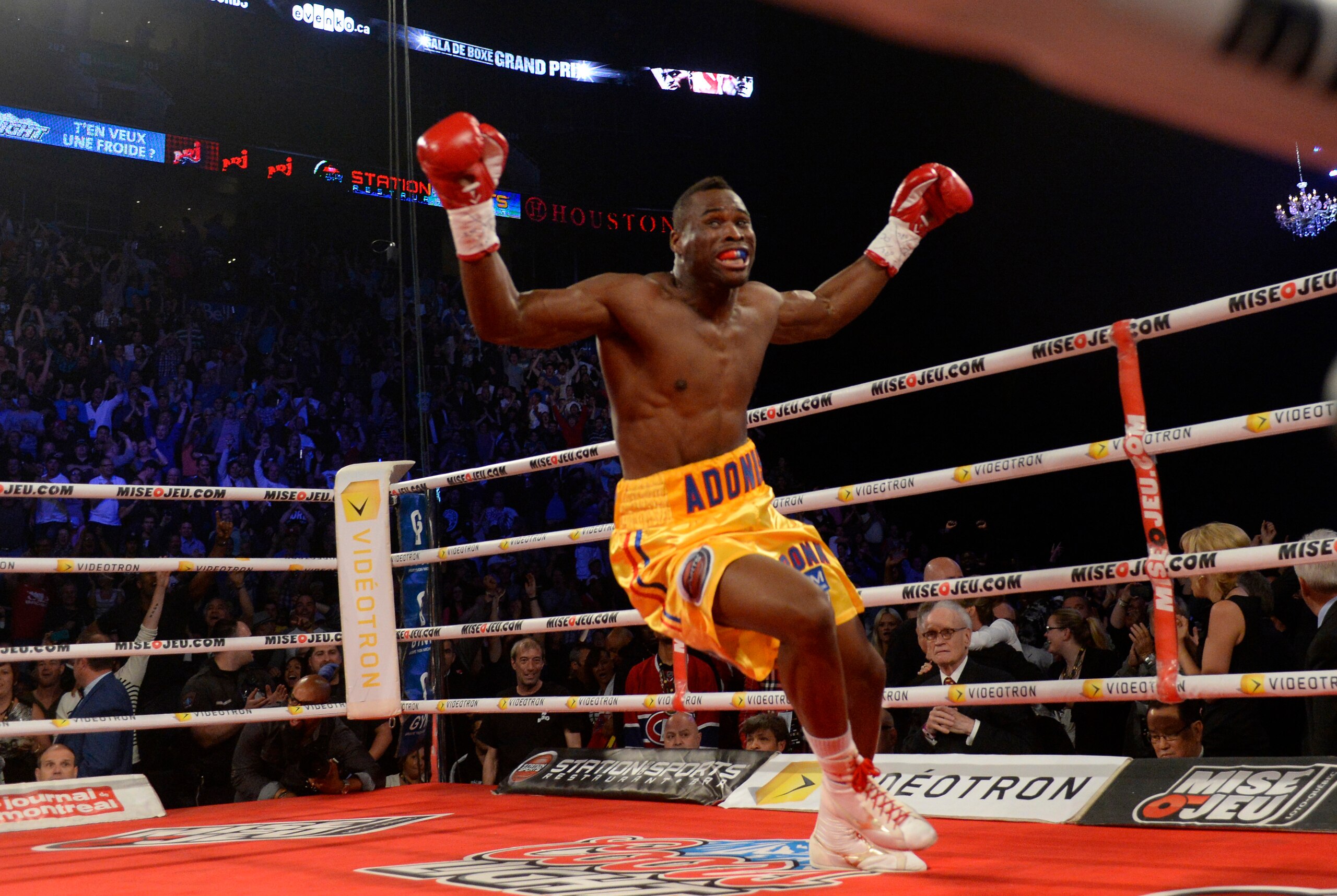 Jun 8, 2013; Montreal, Quebec, Canada; Adonis Stevenson (gold/yellow) celebrates after knocking out Chad Dawson (not pictured) during the first round of their light heavyweight  WBC title bout at the Bell Centre. Mandatory Credit: Eric Bolte-USA TODAY Spo