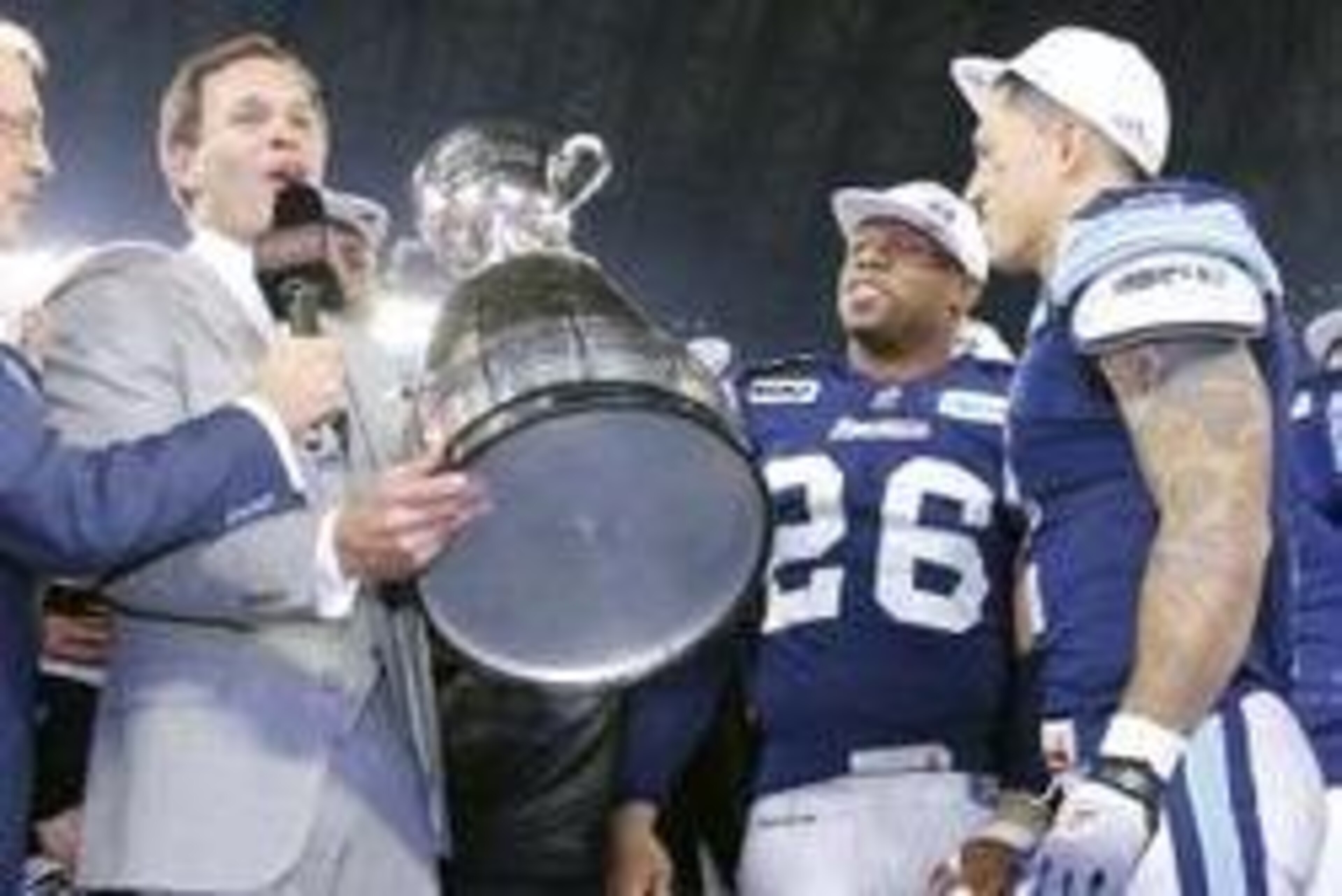 November 25, 2012; Toronto, ON, Canada; CFL commissioner Mark Cohon (left) presents the Grey Cup to Toronto Argonauts safety Jordan Younger (26) and wide receiver Chad Owens (2) after the game against the Calgary Stampeders at the Rogers Centre. Toronto d November 25, 2012; Toronto, ON, Canada; CFL commissioner Mark Cohon (left) presents the Grey Cup to Toronto Argonauts safety Jordan Younger (26) and wide receiver Chad Owens (2) after the game against the Calgary Stampeders at the Rogers Centre. Toronto d
