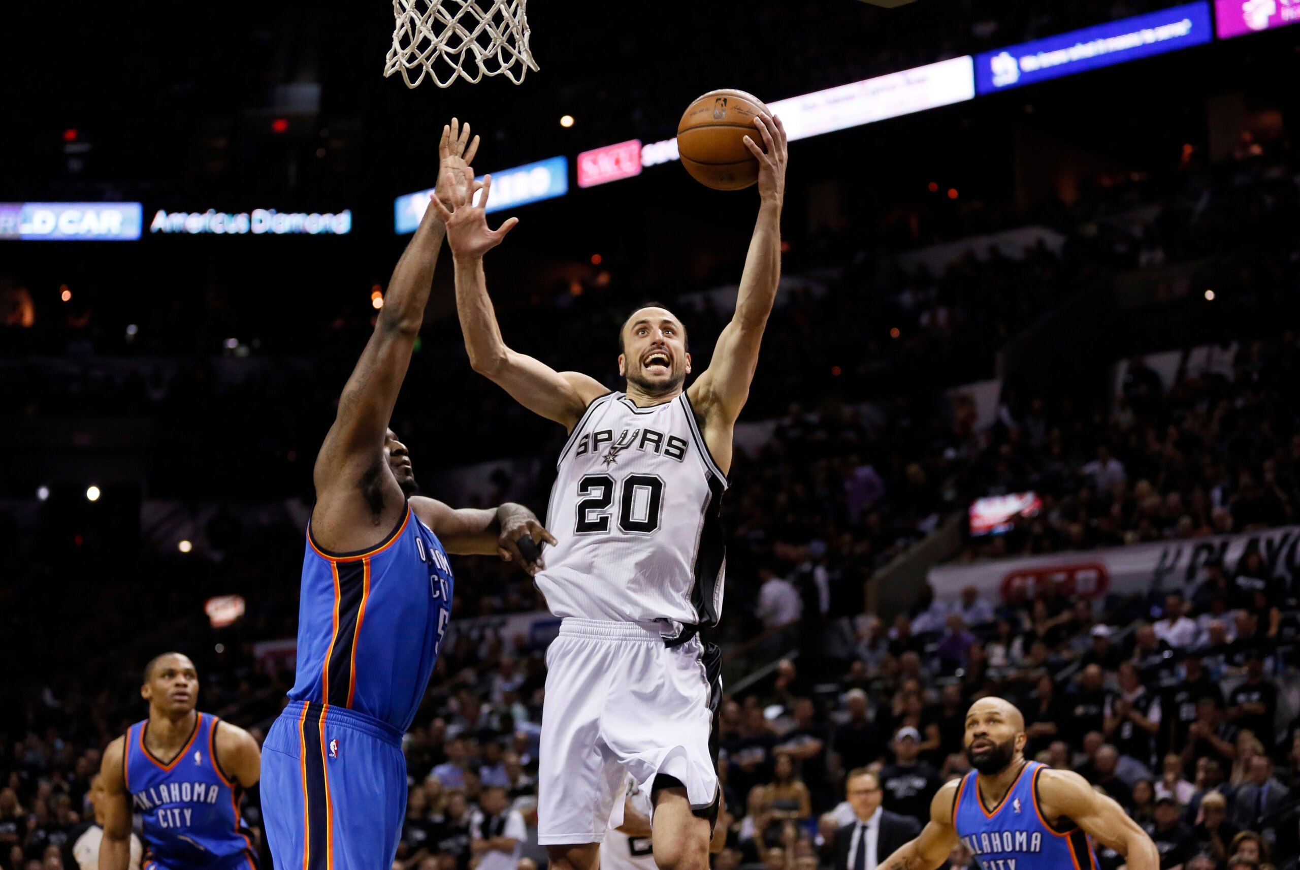 May 19, 2014; San Antonio, TX, USA; San Antonio Spurs guard Manu Ginobili (20) drives to the basket as Oklahoma City Thunder center Kendrick Perkins (5) defends in game one of the Western Conference Finals in the 2014 NBA Playoffs at AT&T Center. The Spur